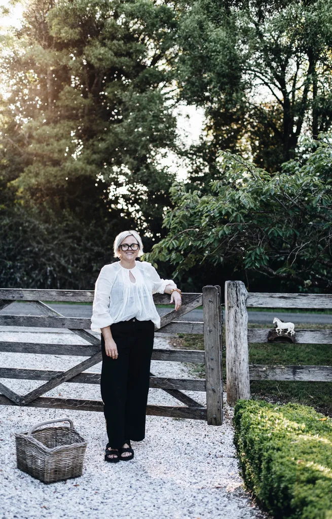 Homeowner Beth Macdonald at the front of her old timber gate