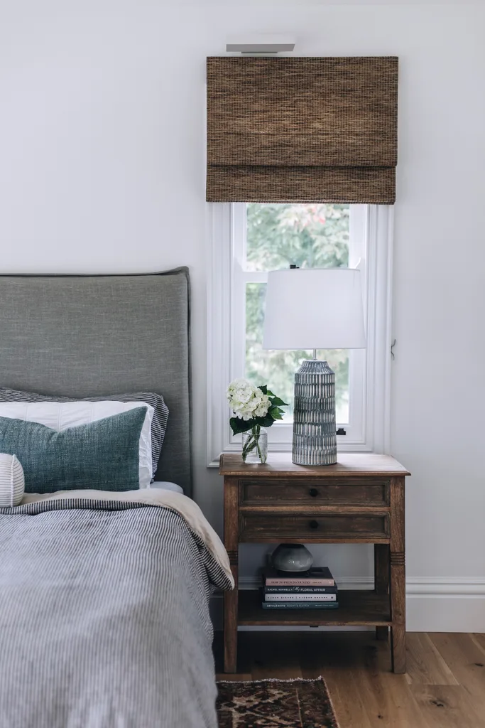 Bedroom with timber bedside tabled and a bed with a striped duvet cover