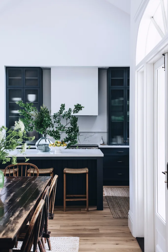 A dark blue and white modern kitchen