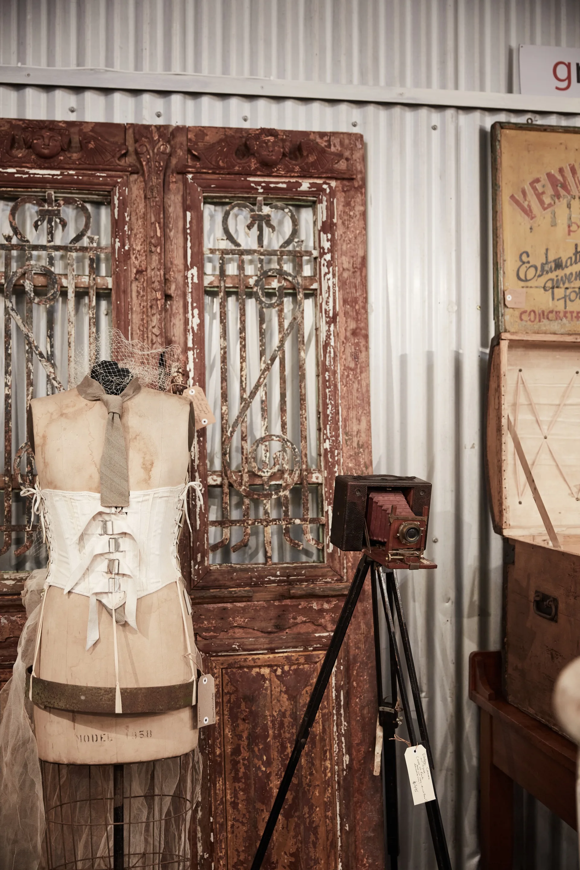 Close up of an old camera, a dressmaker's dummy and an old door with flaking paint
