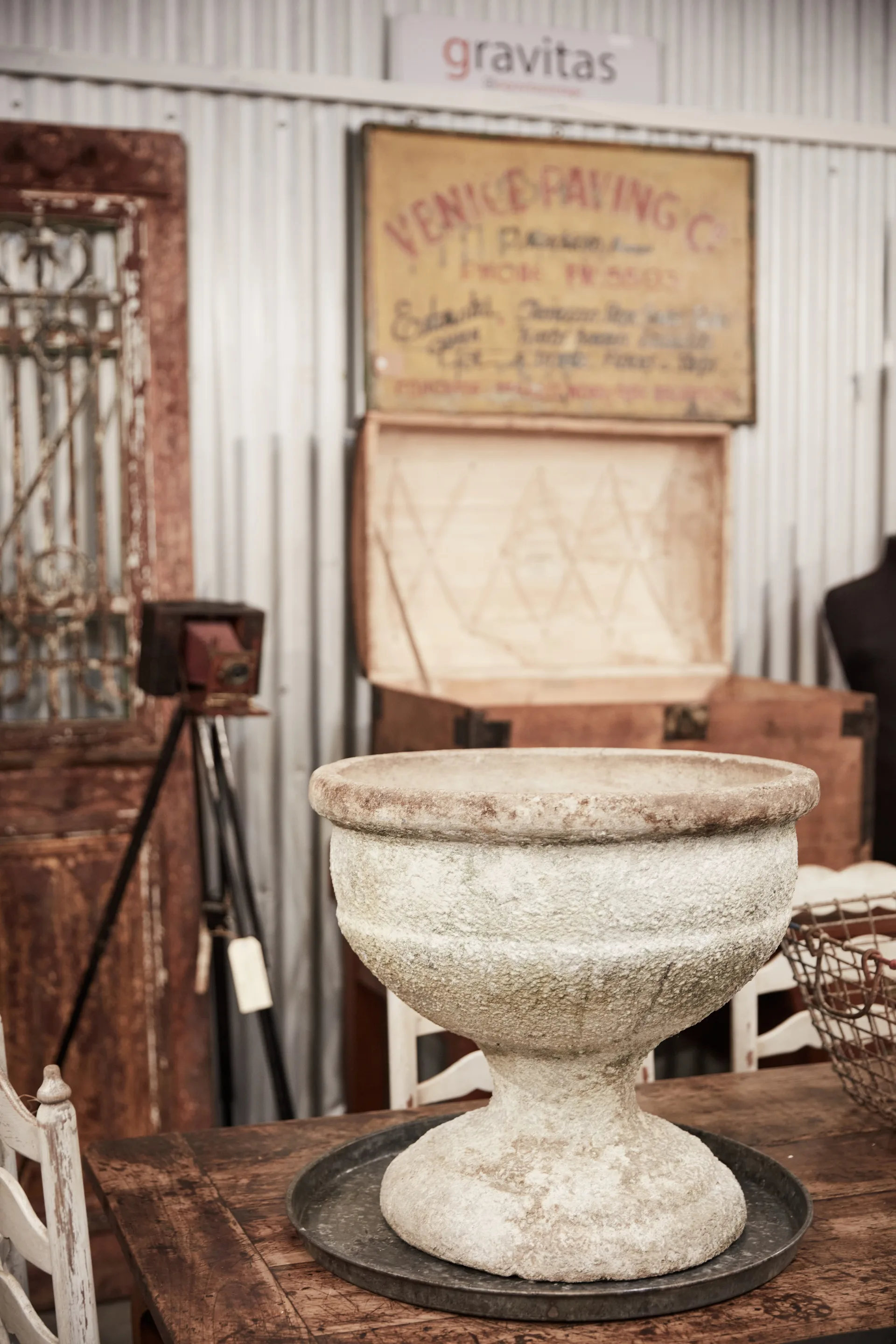 A close up of an old white pot planter