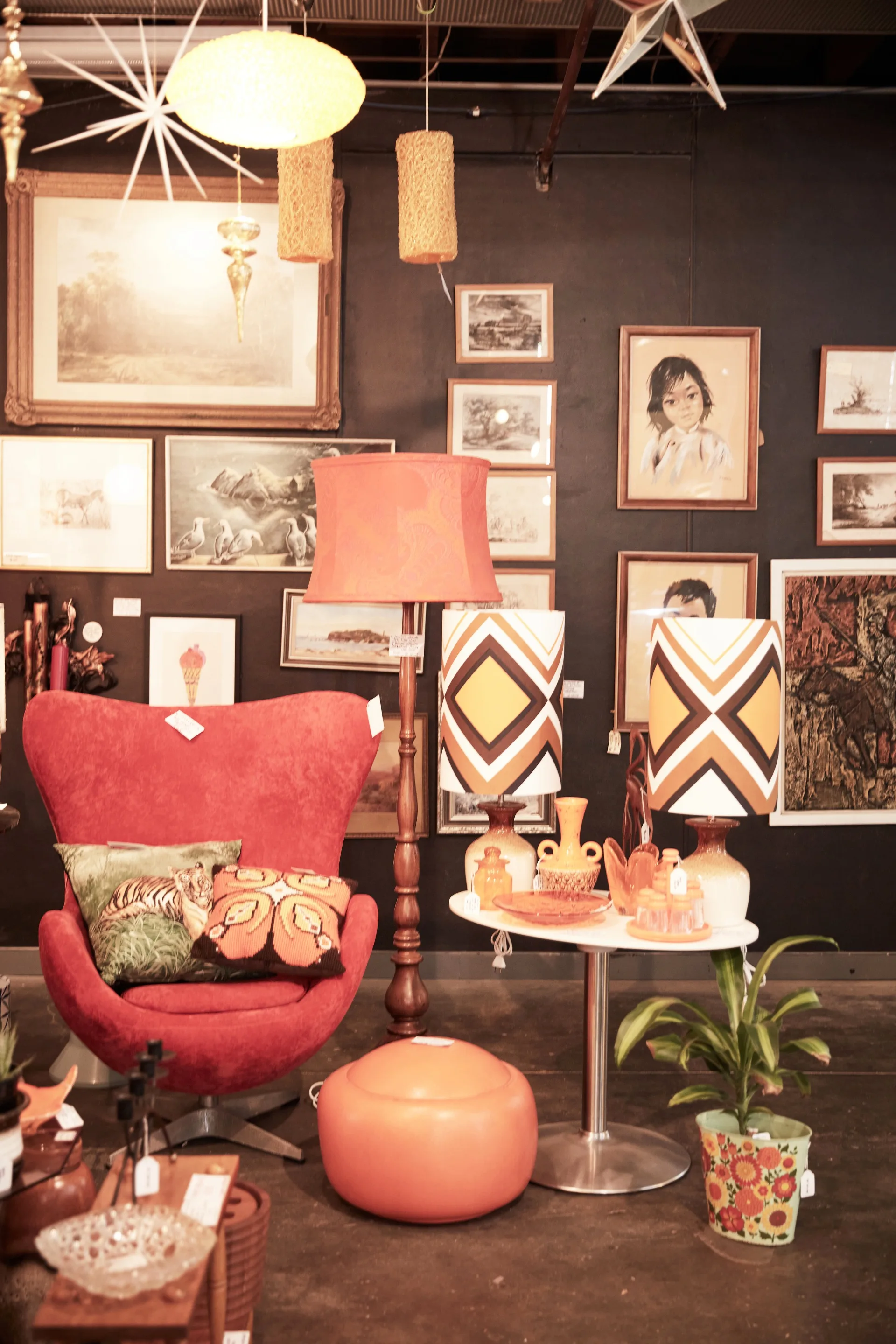 A retro red armchair next to 70s-style lamps