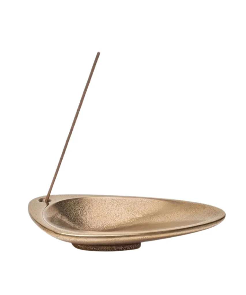 A brass organic-shaped incense holder from Aesop