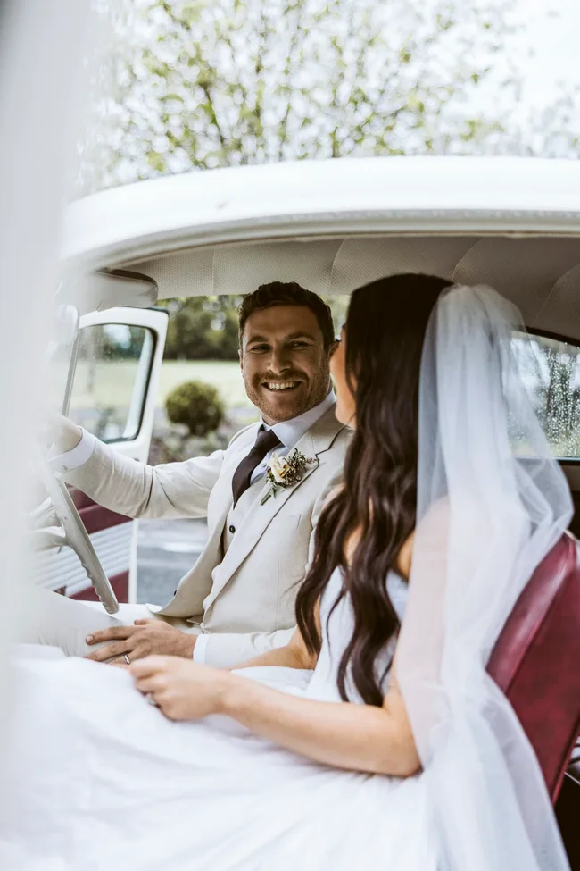 Lucy and Jack sitting in a vintage VW Beetle