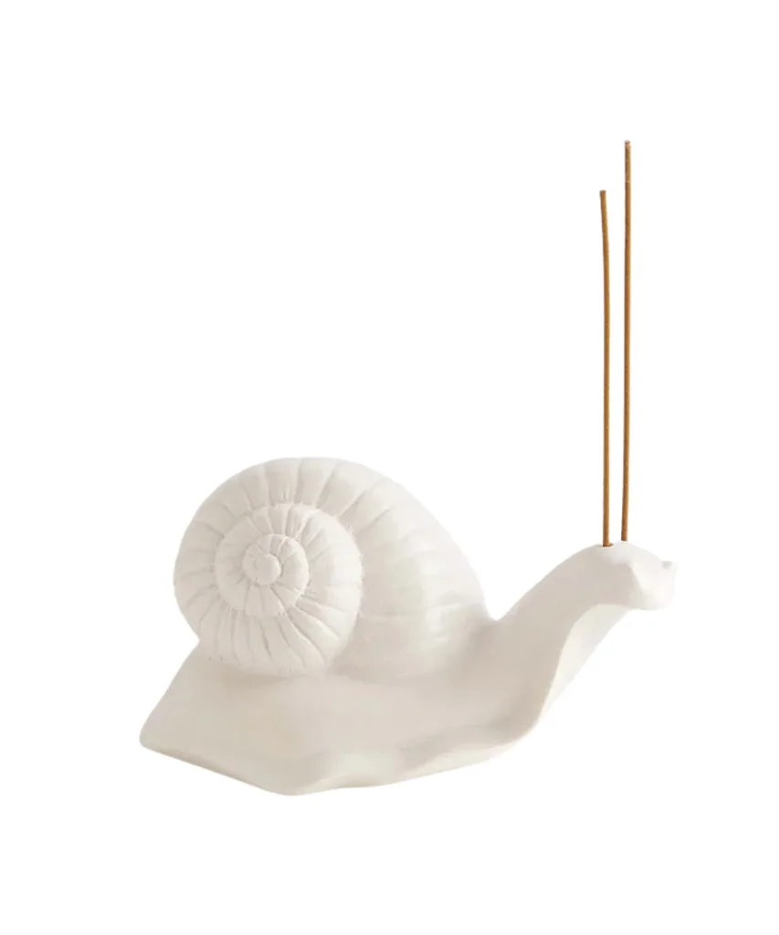 A white snail-shaped incense holder from Maison Balzac