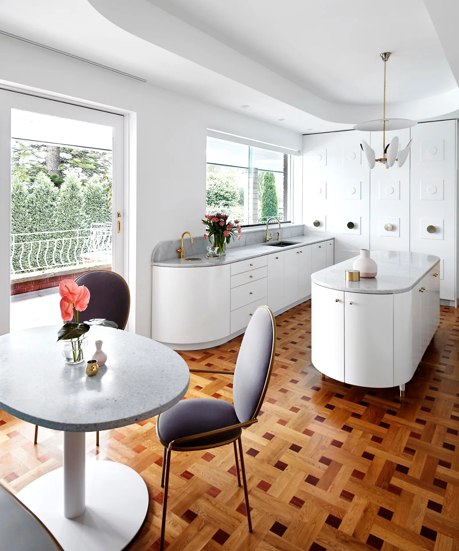 Kitchen with circular island bench and parquetry flooring