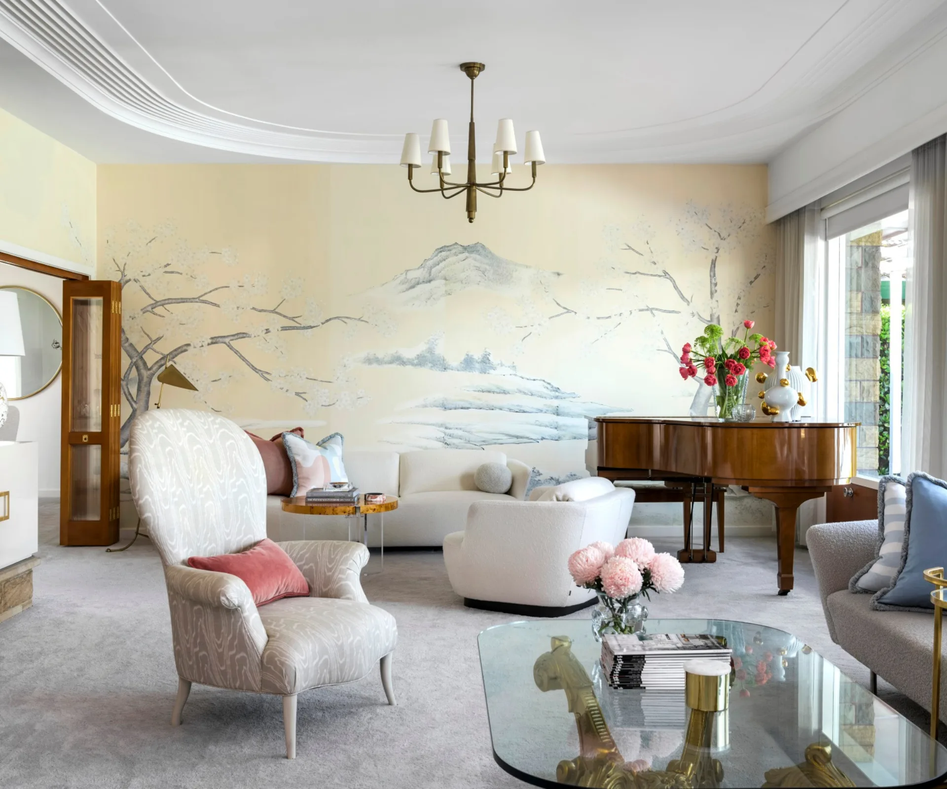 Large formal living room with piano and chandelier