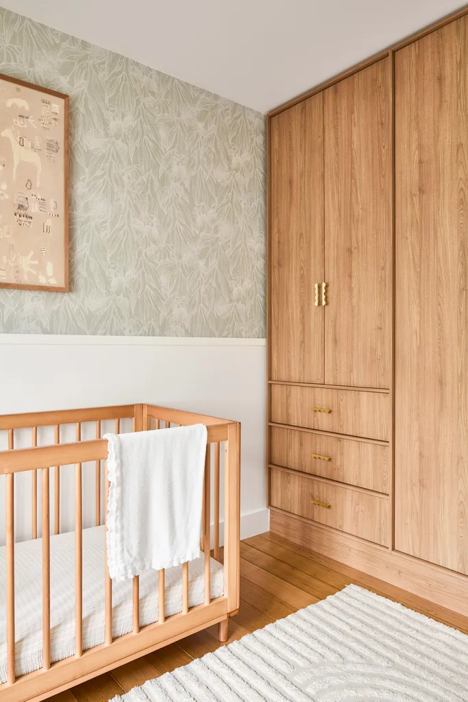 timber cot and wardrobes in nursery