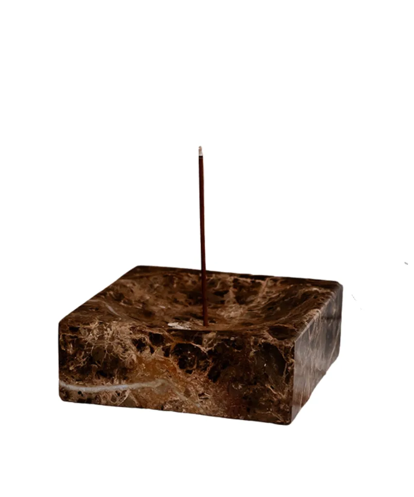 A dark marble square-shaped incense holder