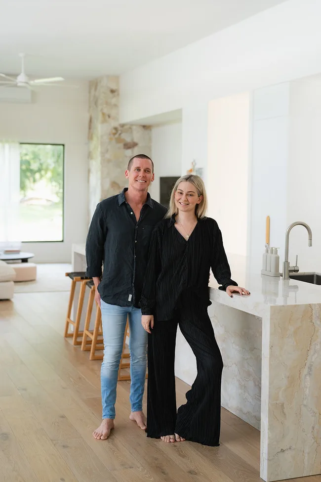 Former Block contestants Tess and Luke standing in a white kitchen