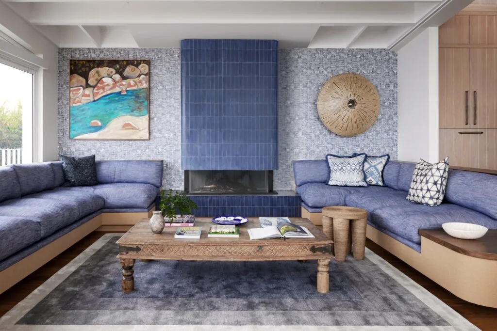 A blue-toned living room with built-in seating and a fireplace