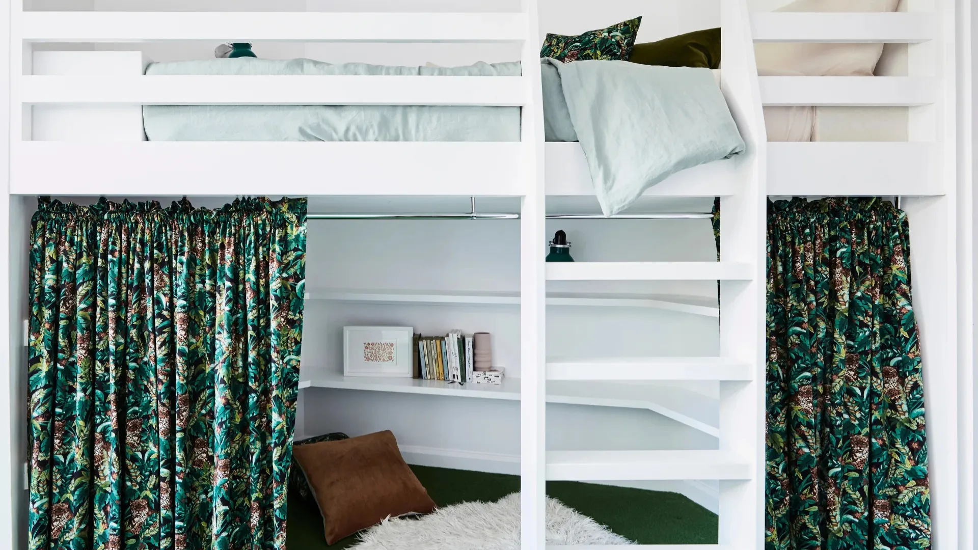 A white loft bed in a bedroom with green carpet