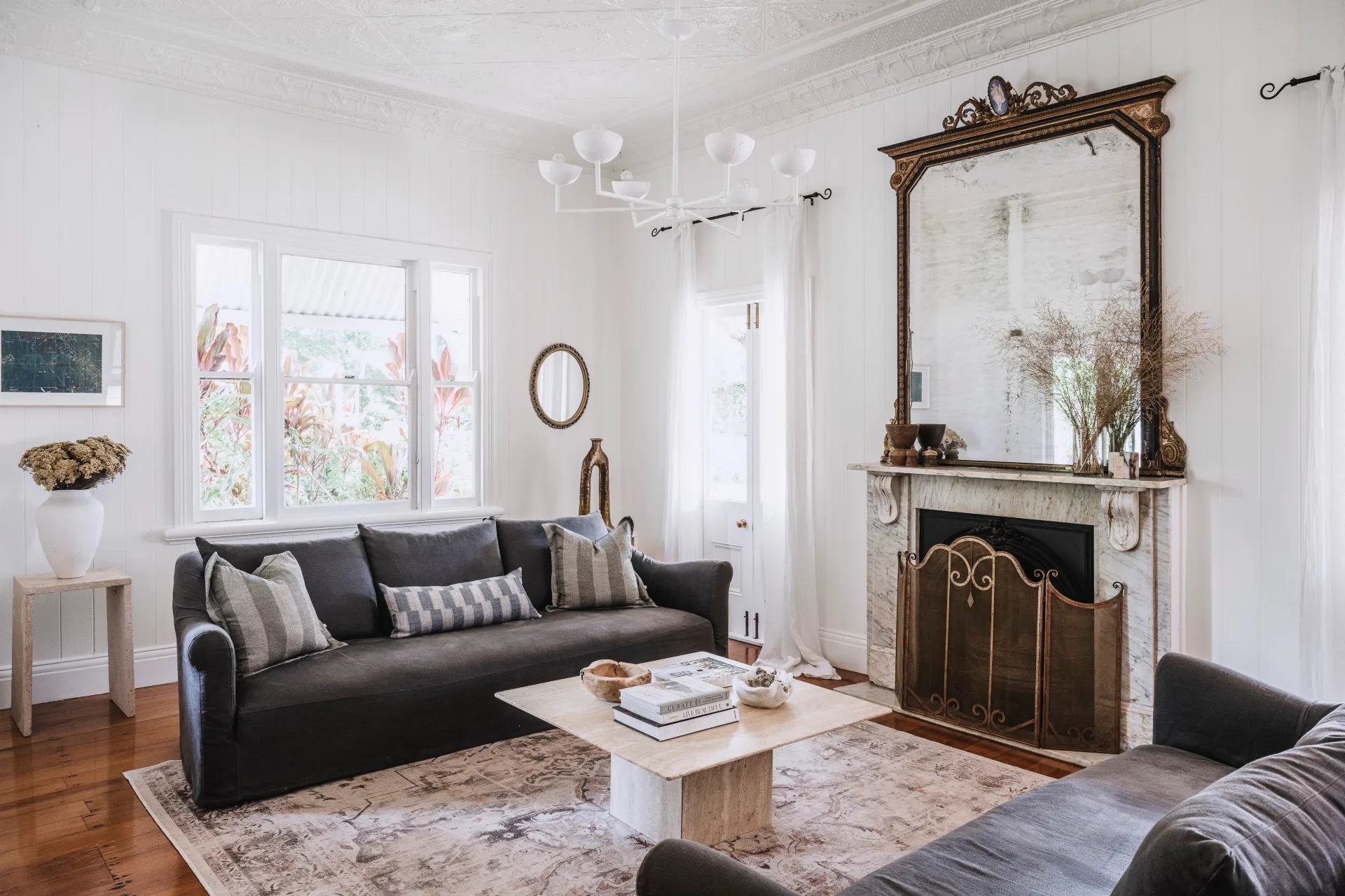 a country living area with a vintage mirror and original fireplace