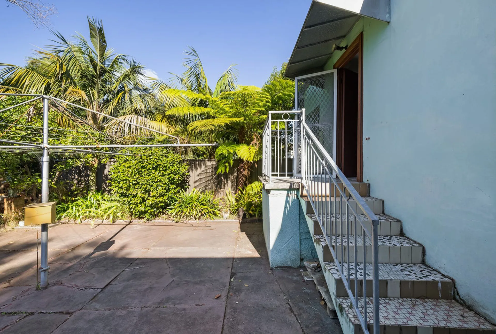 home back door and garden with hills hoist