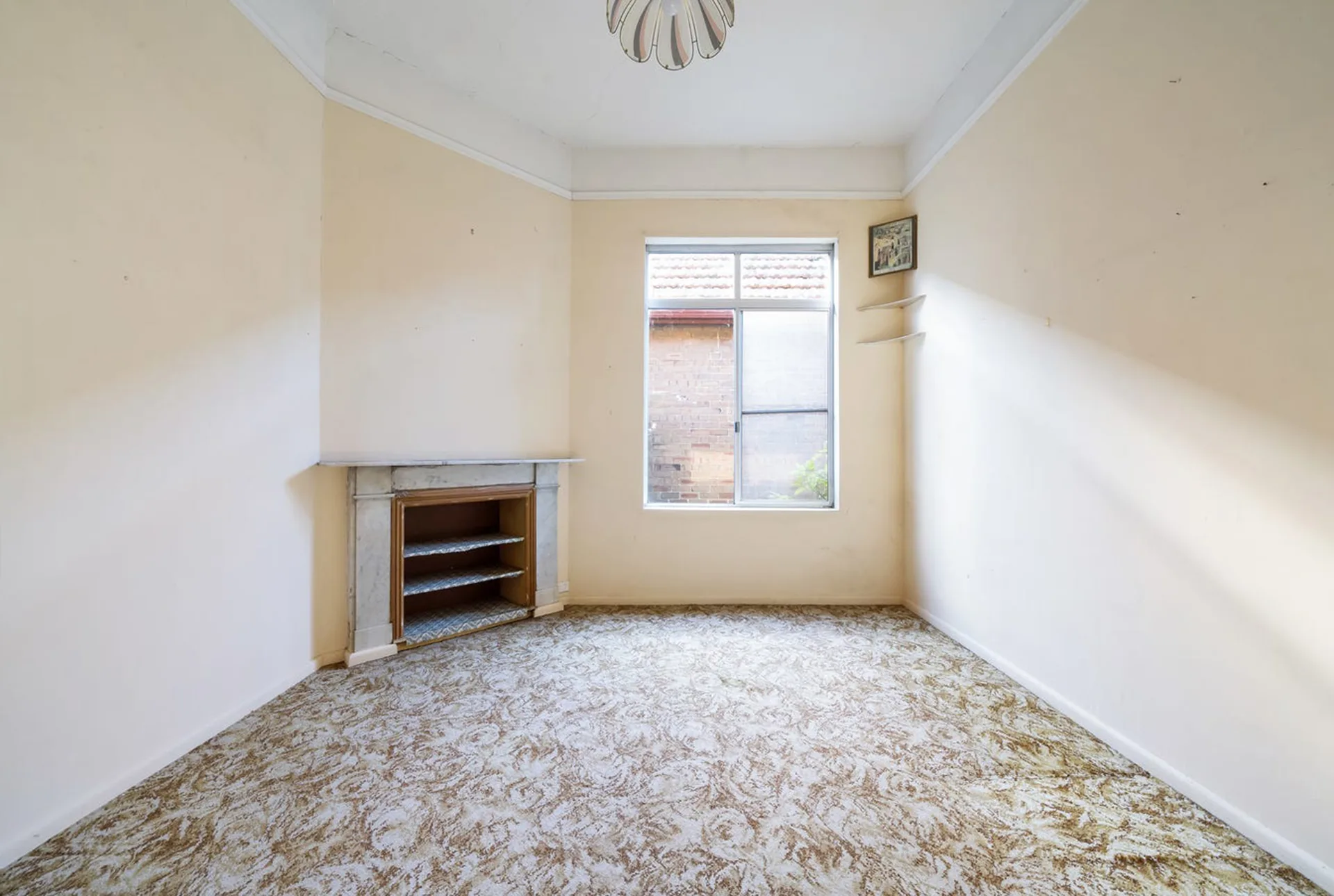 original bedroom with fireplace and old carpet