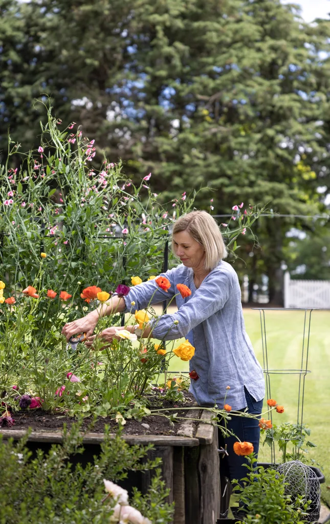 Home owner Anita tending to her flowers in the garden