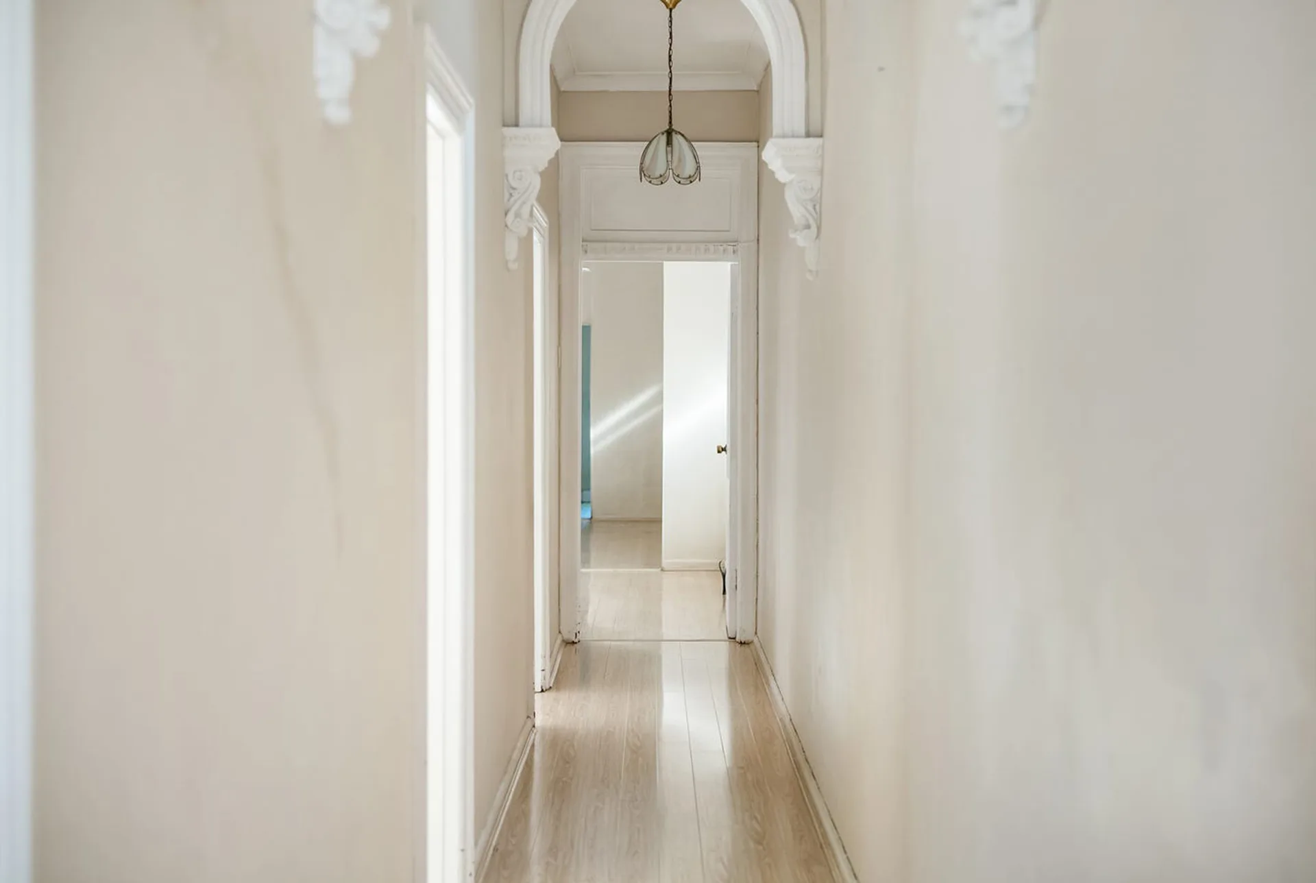 classic traditional white hallway with ceiling mouldings