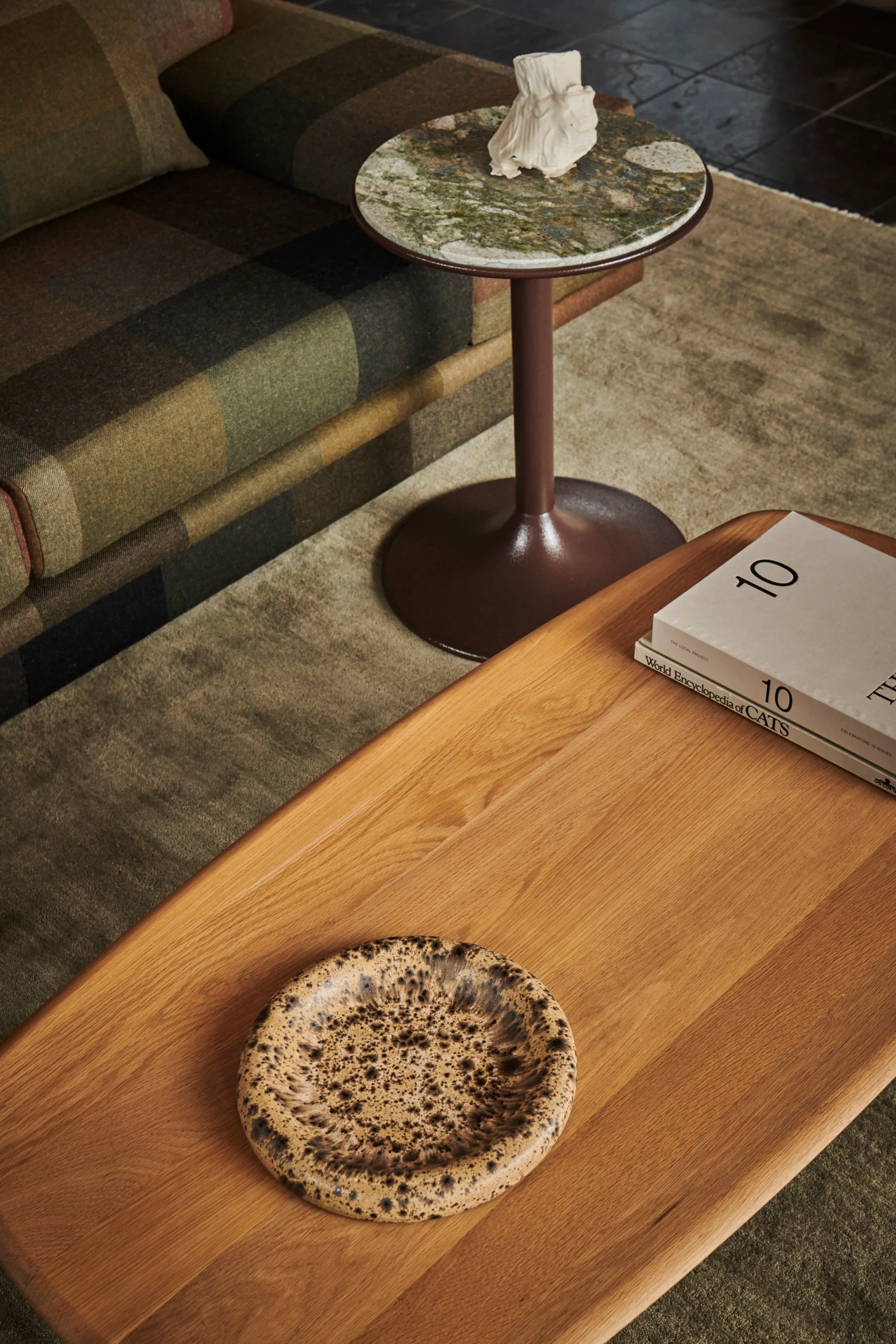 A timber coffee table and a plaid couch