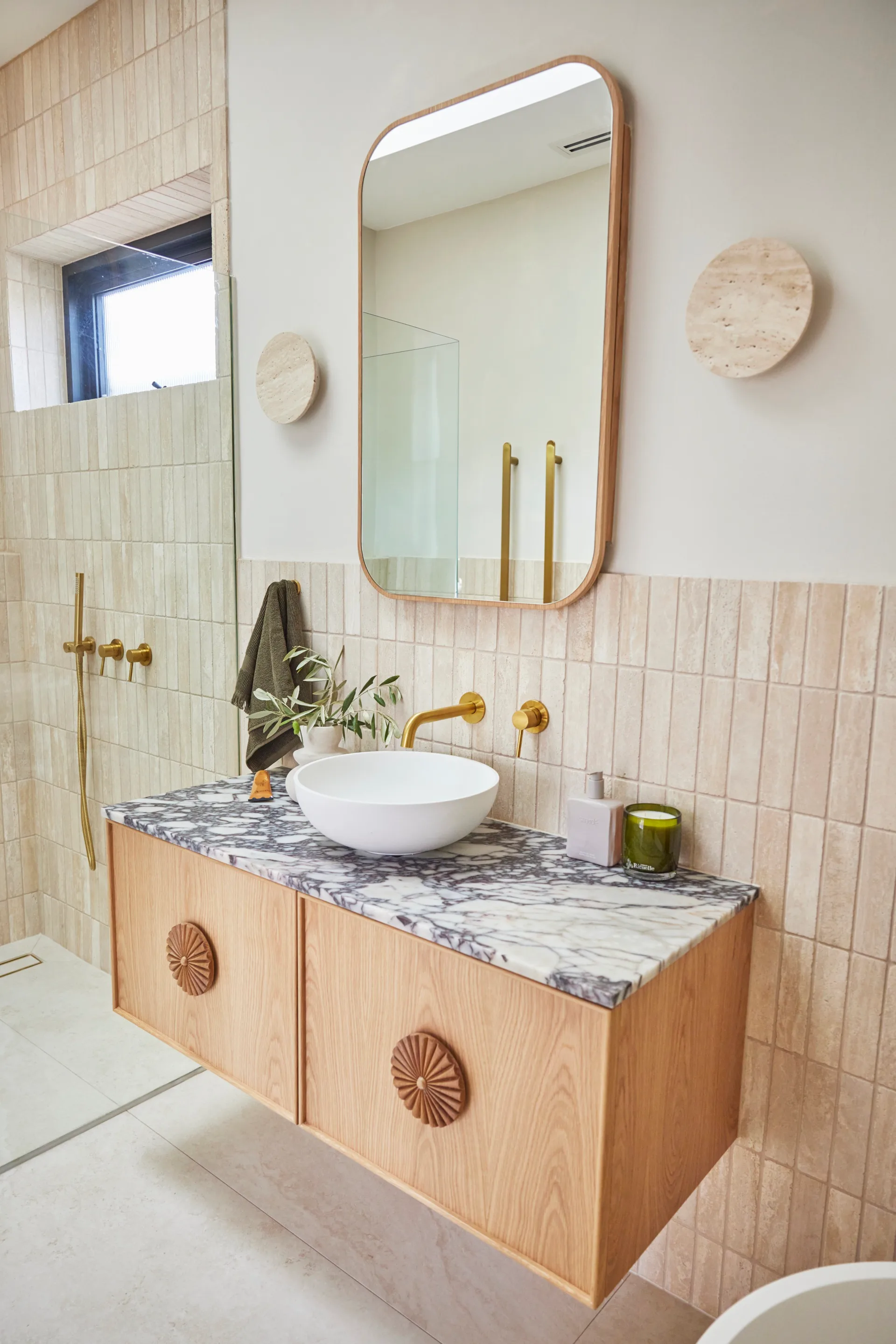 the block 2024 main bathroom with timber and marble vanity and beige tiles