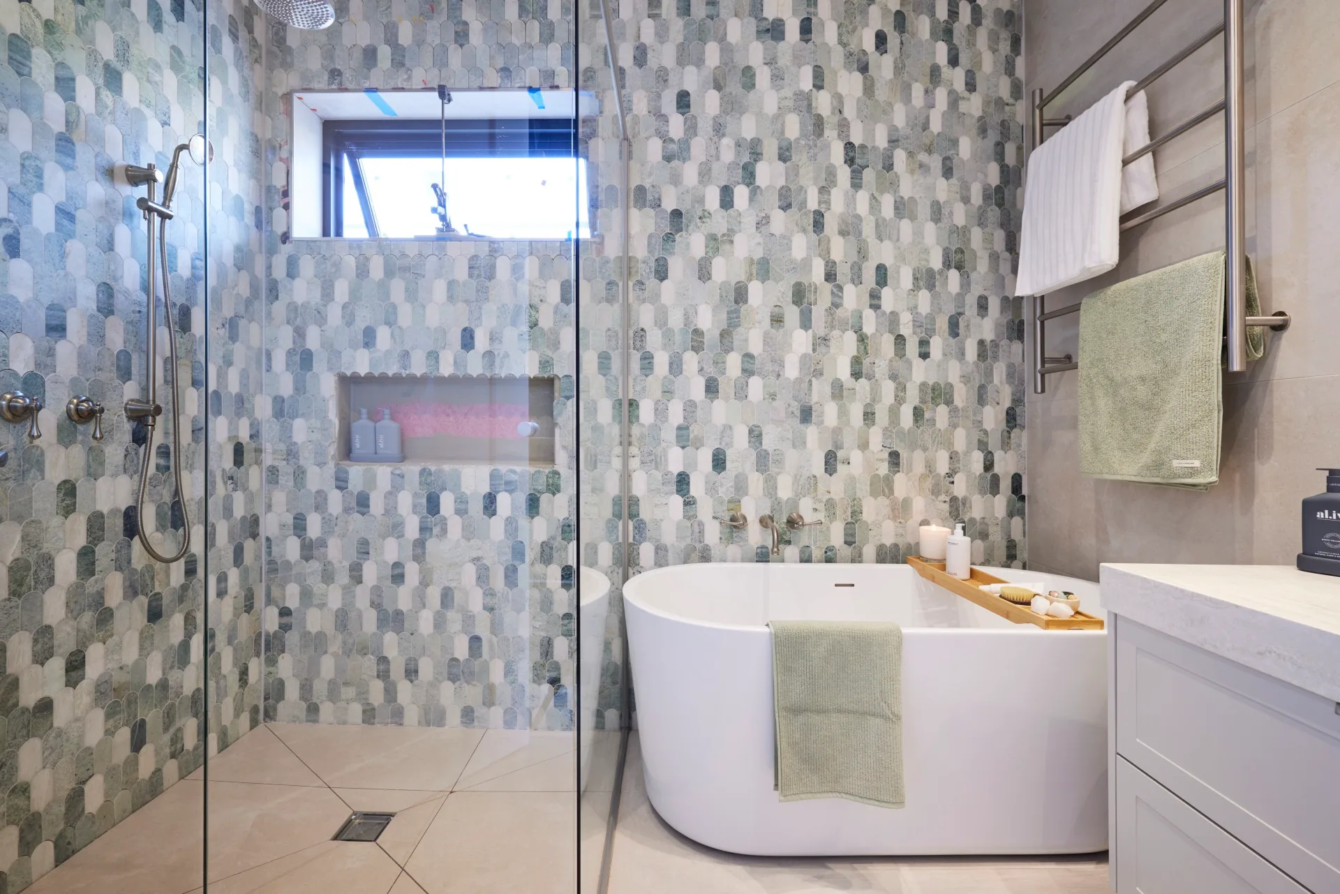 jesse and paige main bathroom with blue fish tiles and freestanding bath