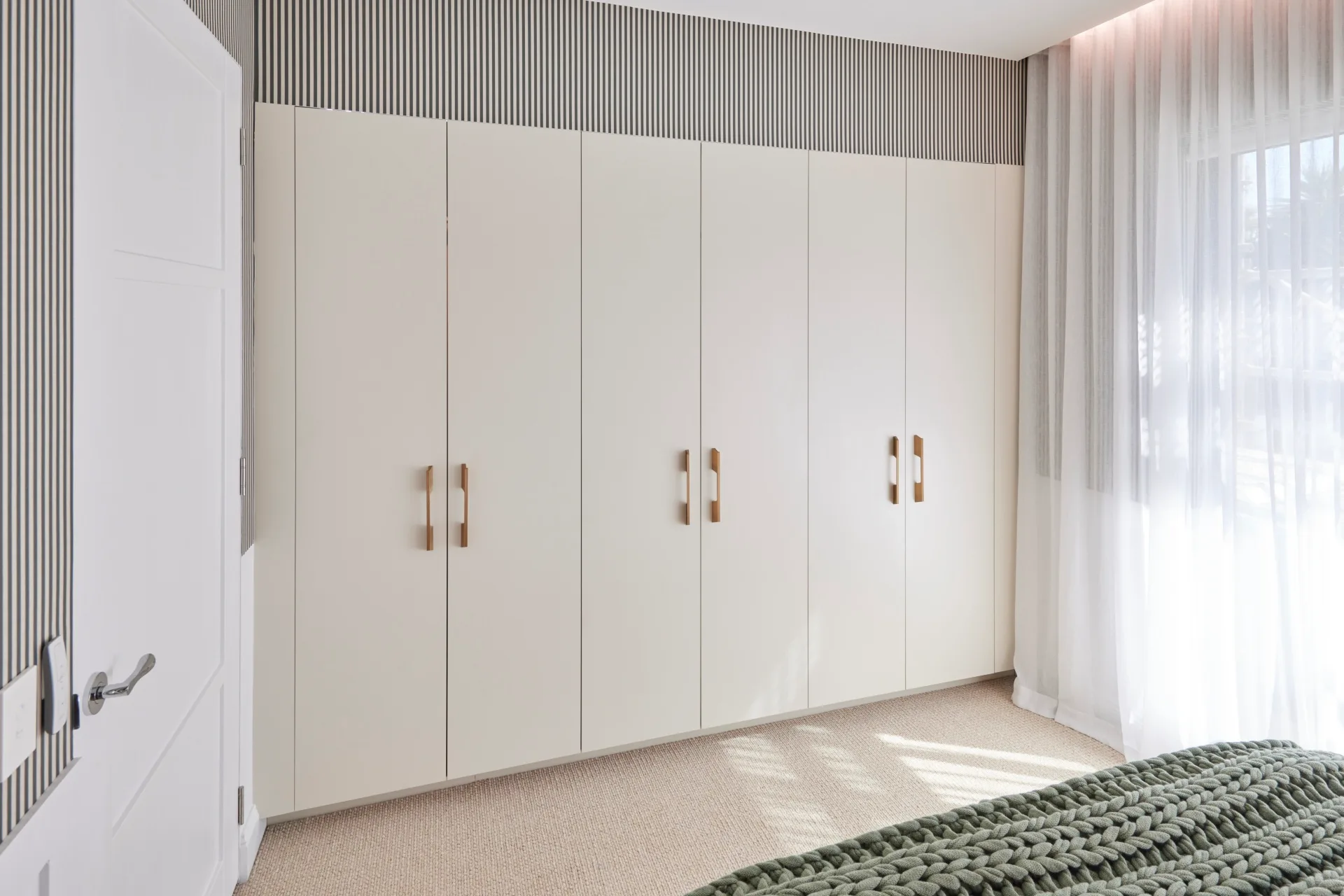 White cupboards in Jesse and Paige's guest bedroom