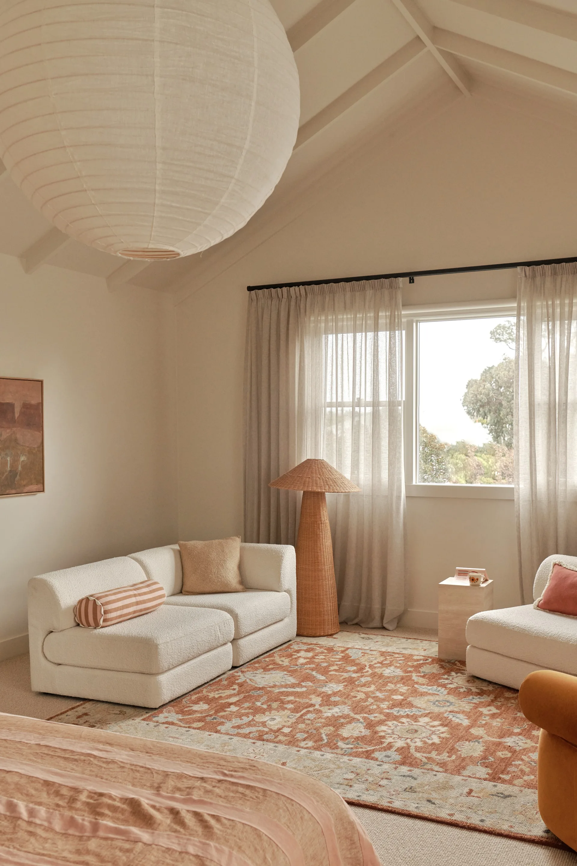 A peach and orange-toned lounge space in a master bedroom