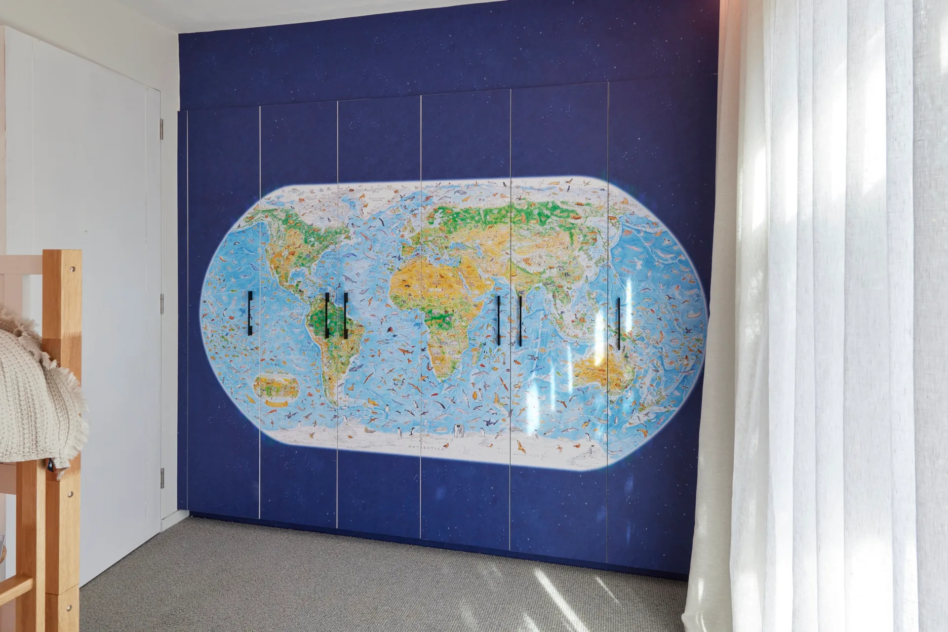 A wardrobe covered in world map wallpaper