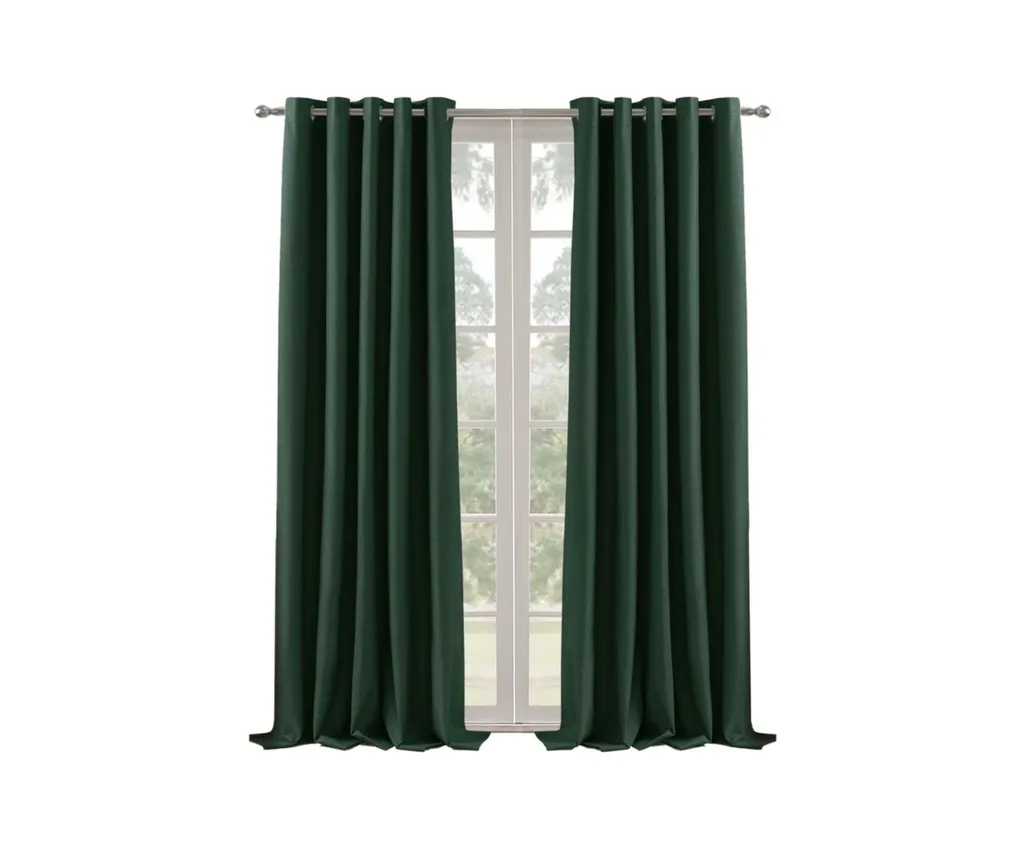 Emerald green curtains on a silver curtain rod by a window
