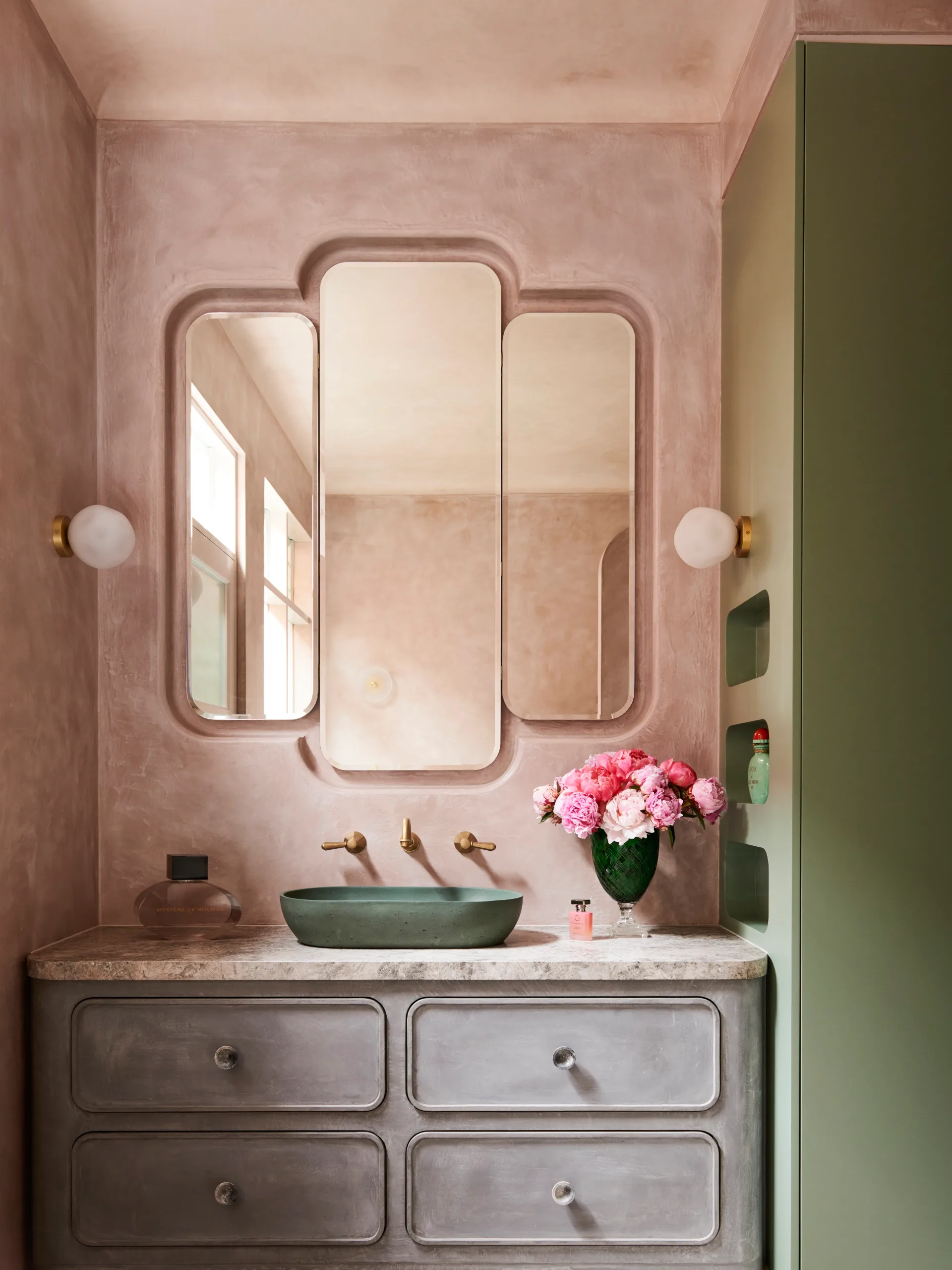 Art Deco style pink microcement bathroom with sage green joinery