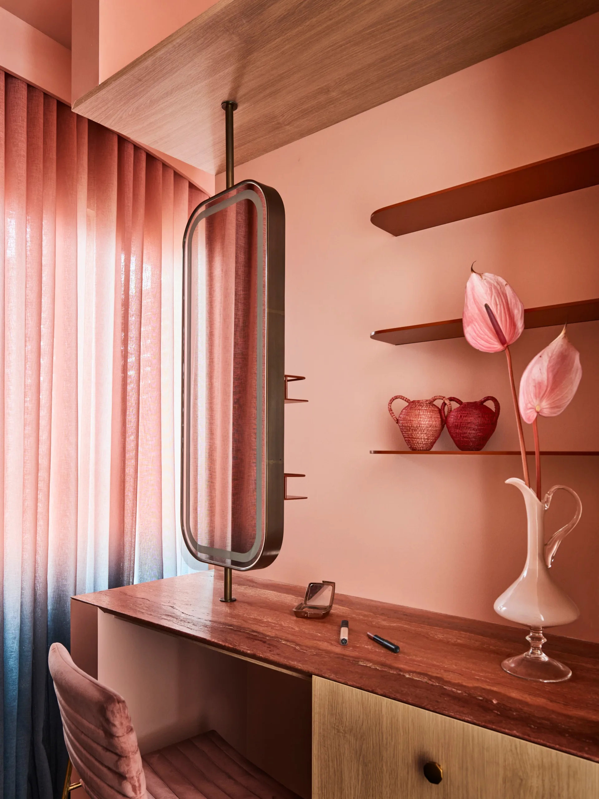 A dressing room with makeup station in a coral-coloured bedroom