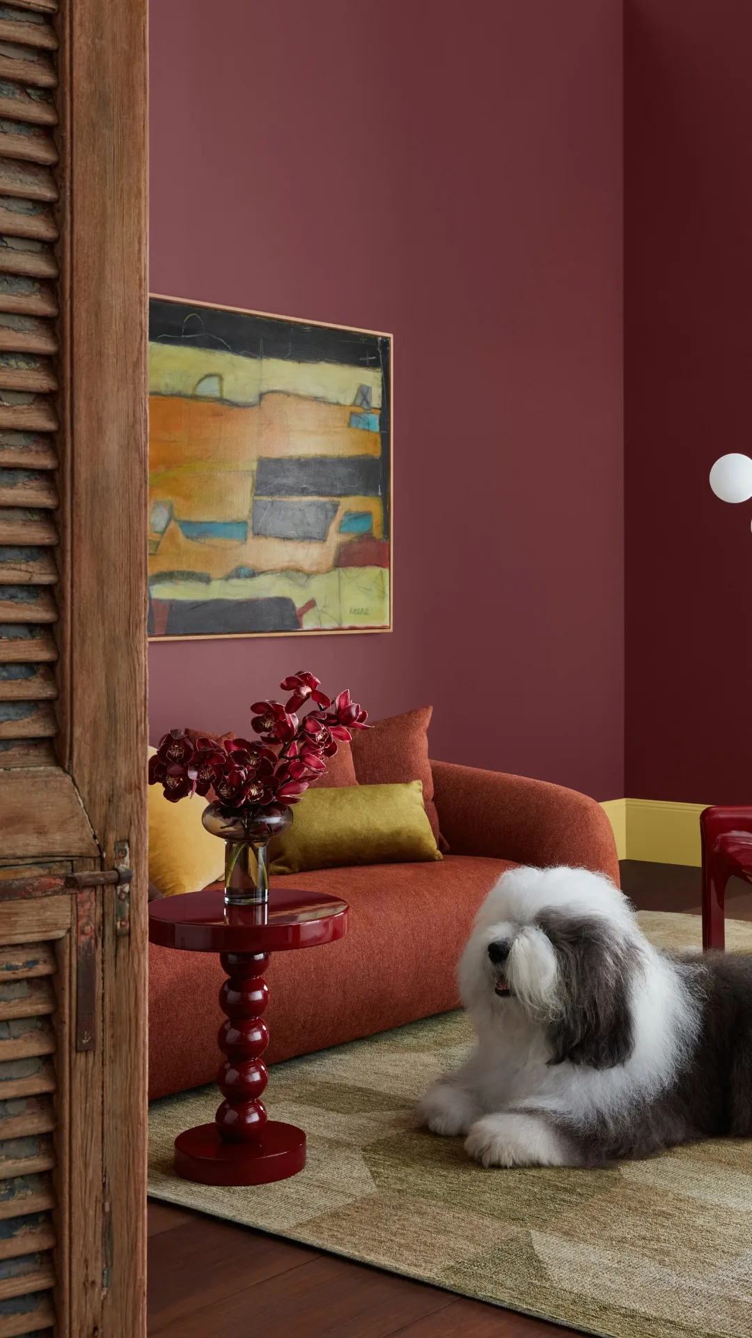 Sitting room setting with a deep red paint backdrop