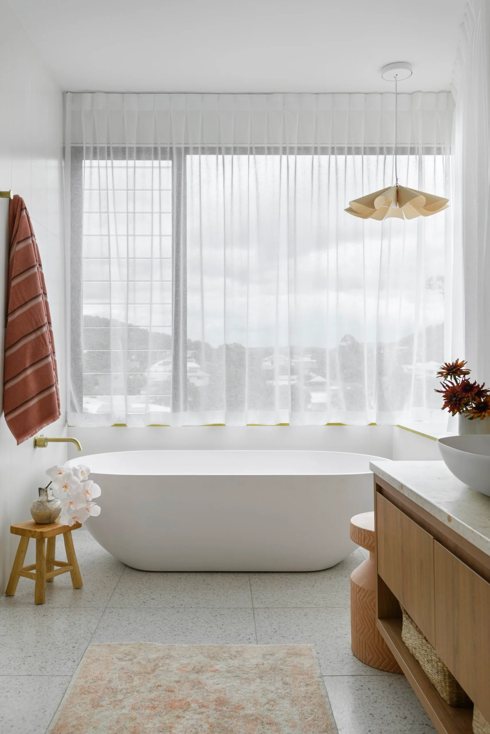 A freestanding bathtub in a white bathroom