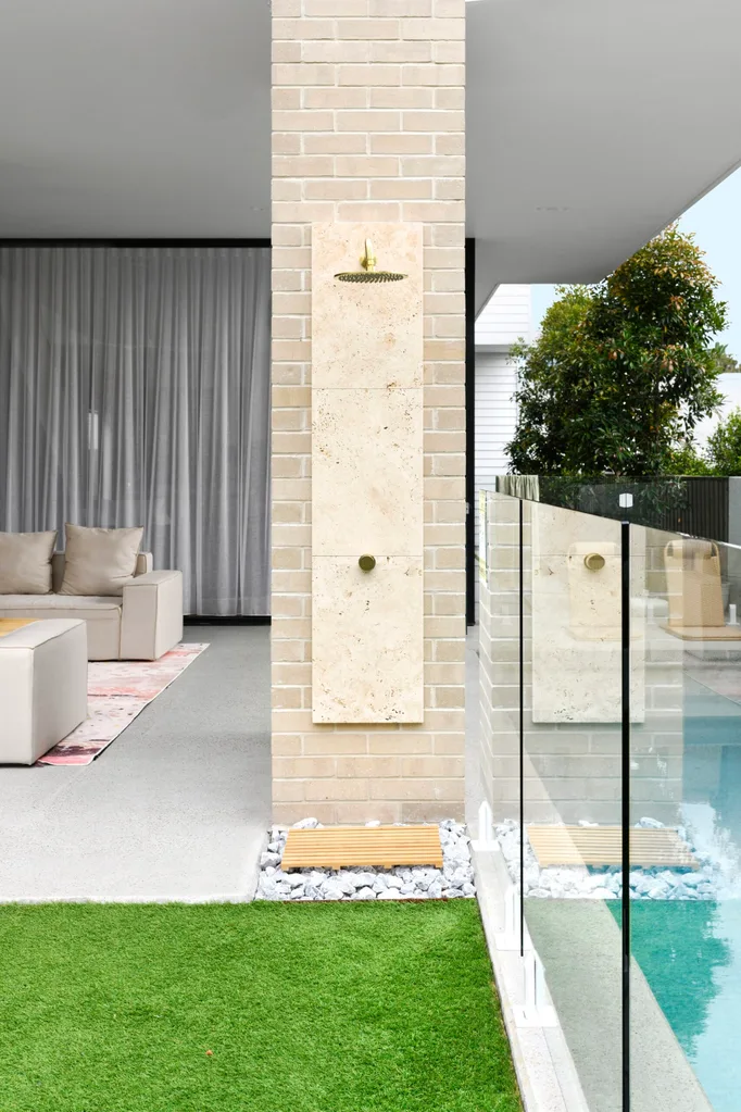 An outdoor shower beside the lap pool
