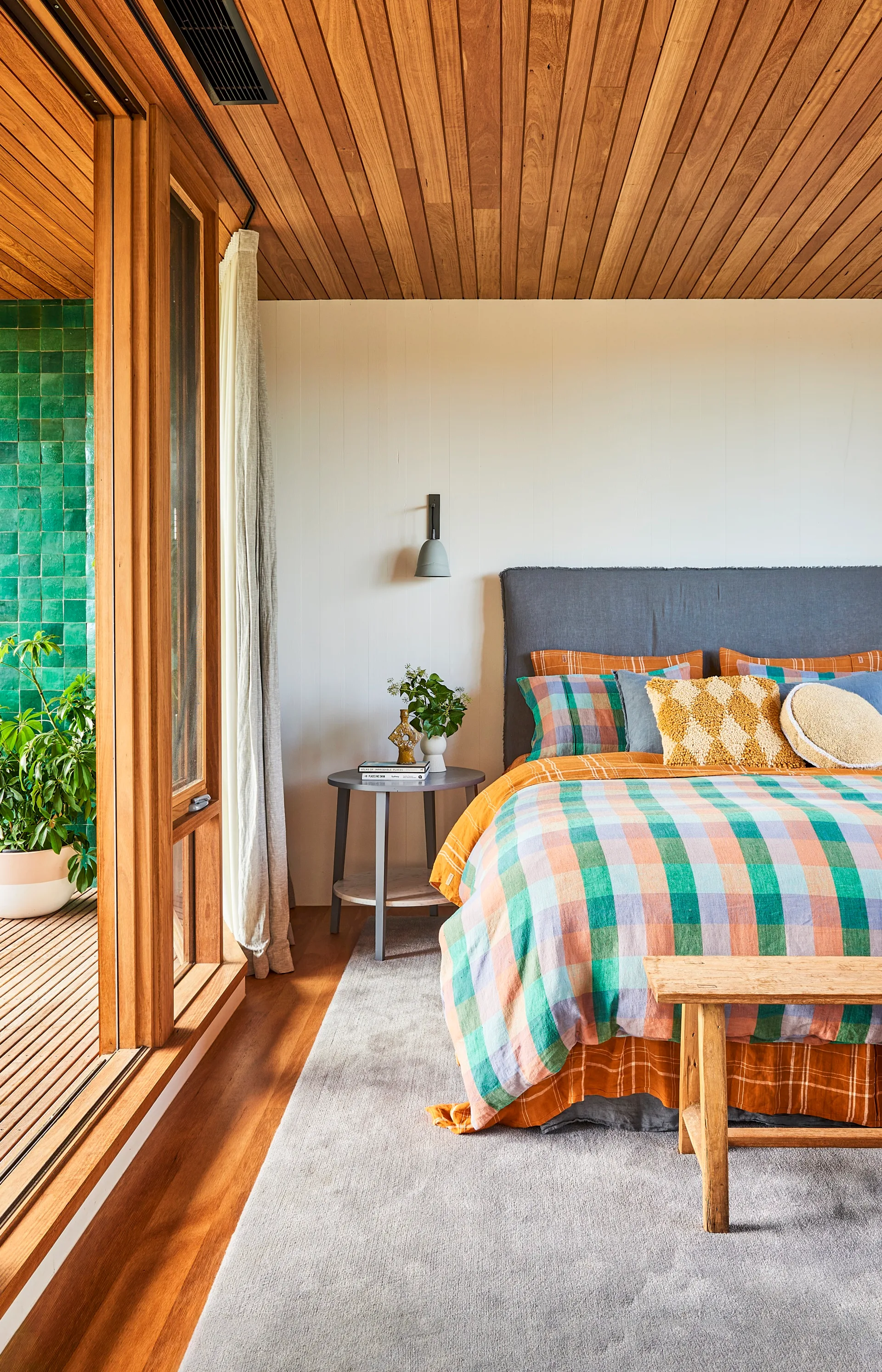 A bright and colourful bedroom with an adjoining alfresco area