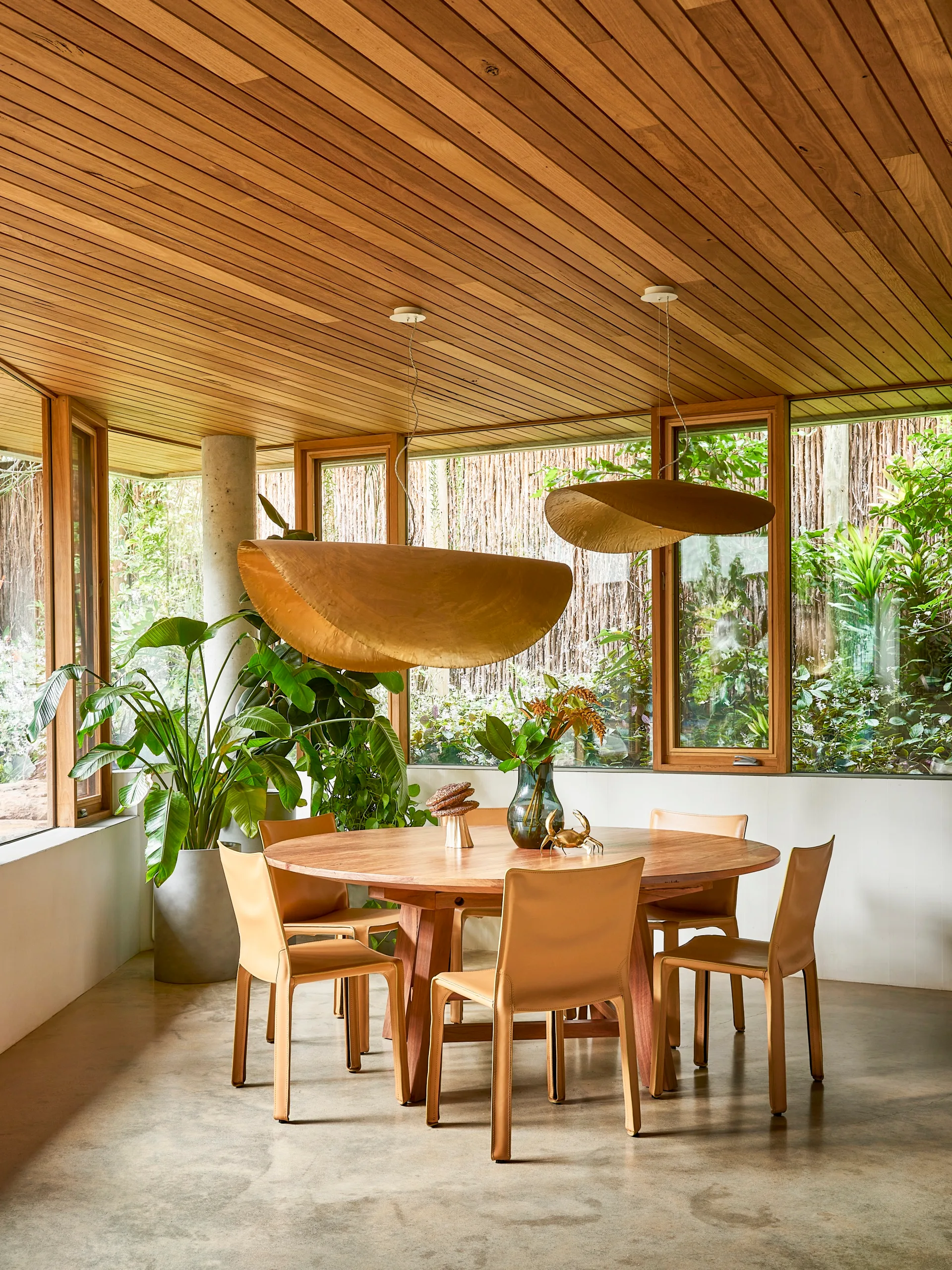 A timber dining area with statement pendant lights