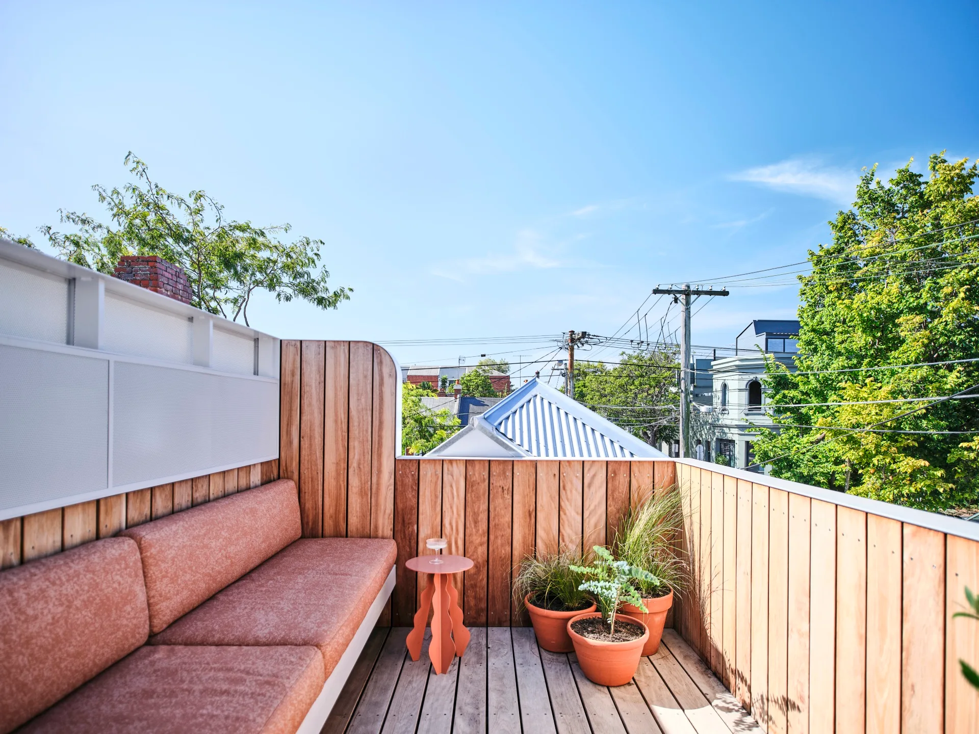 A sunny rooftop terrace with built-in seating