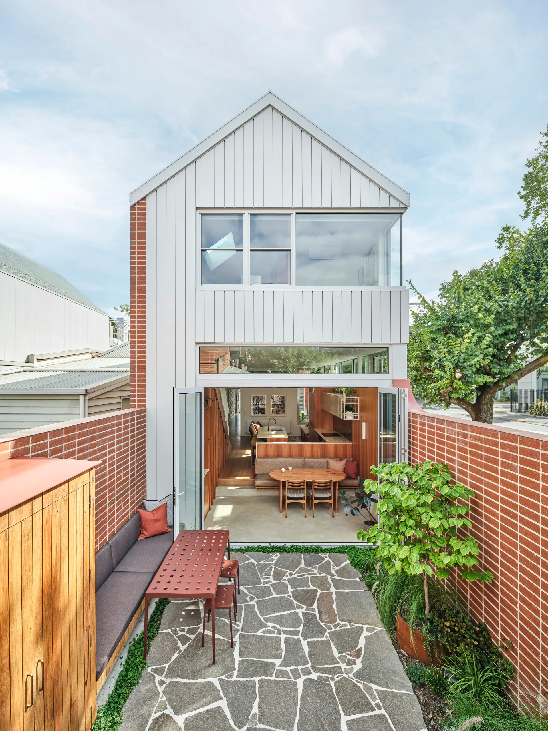 The exterior of a two-level home clad in metal sheeting