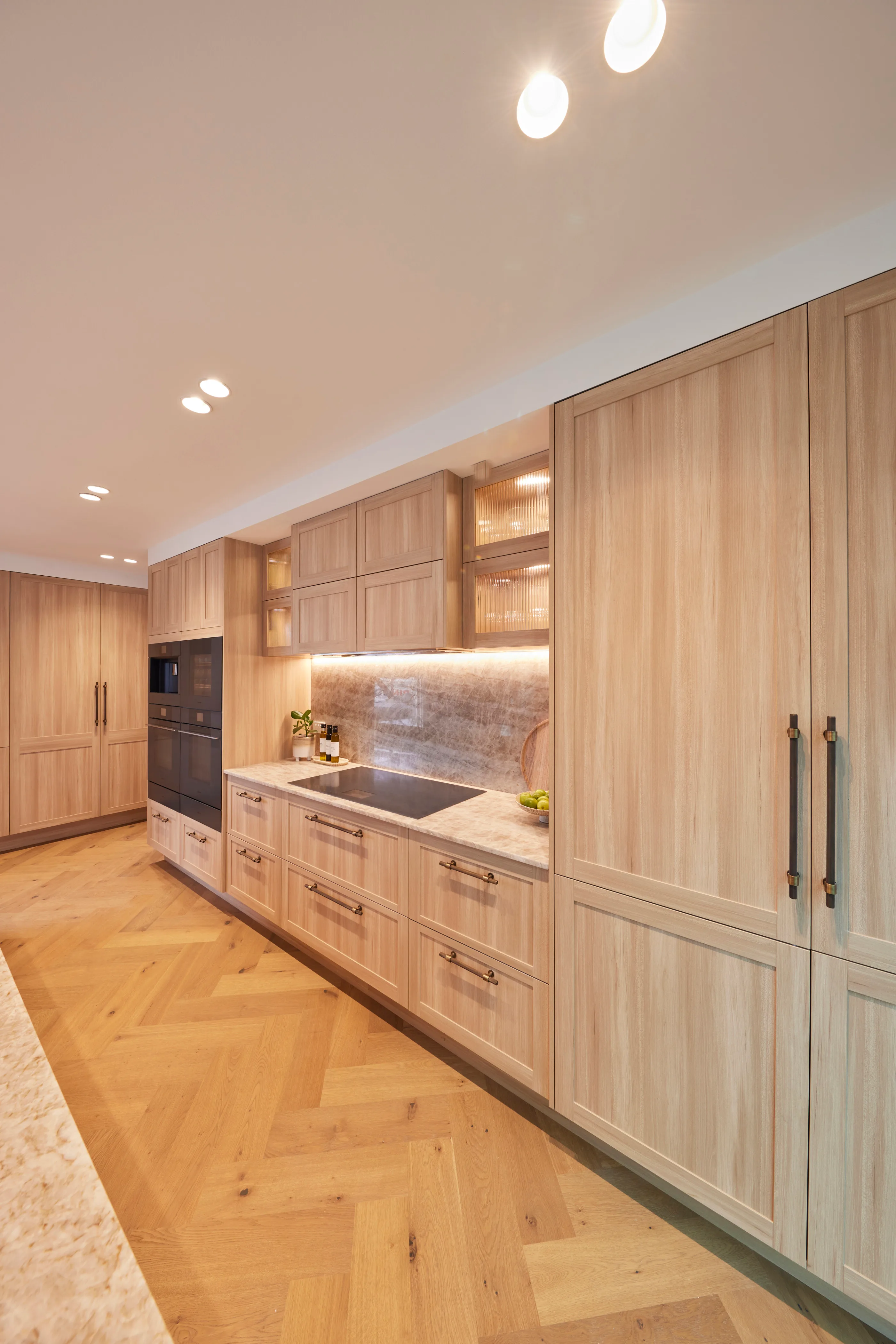 A contemporary kitchen with oak cabinetry