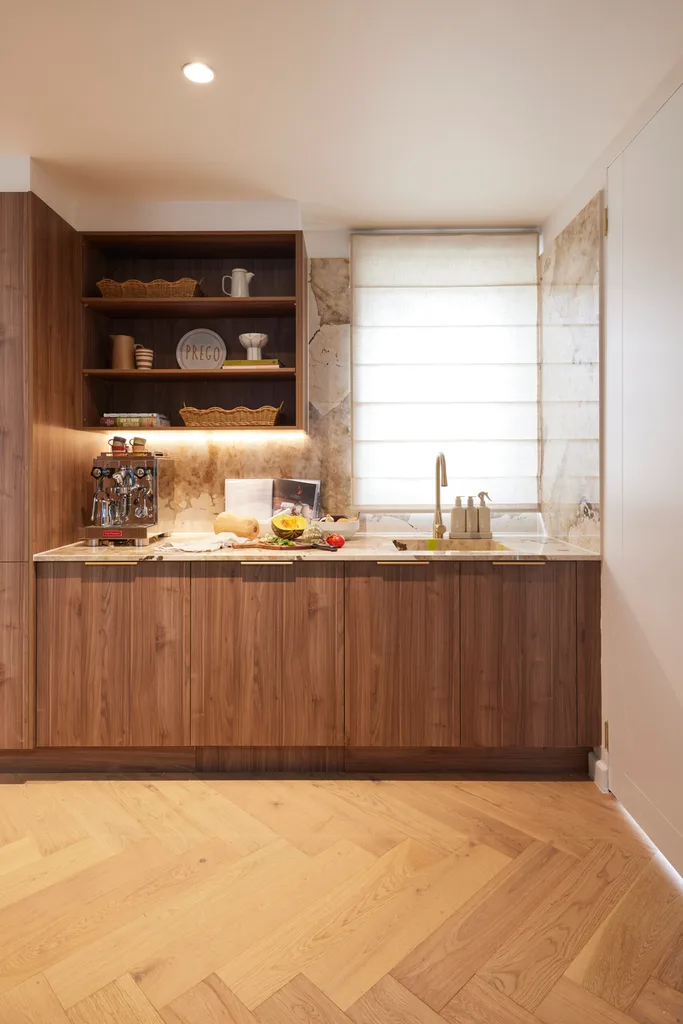 A butler's pantry with timber cabinetry and a marble-style splashback