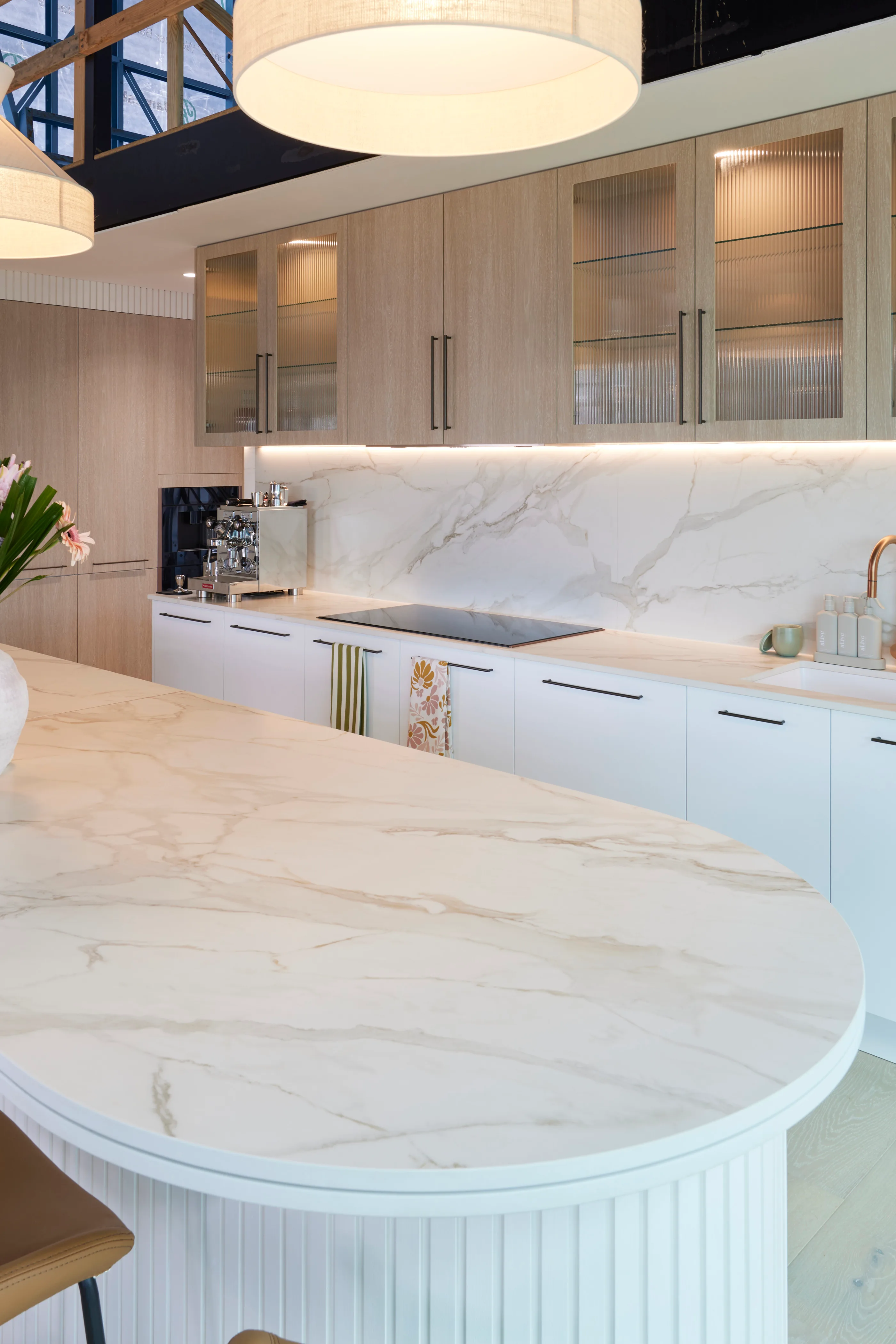 A curved island bench with a marble finish