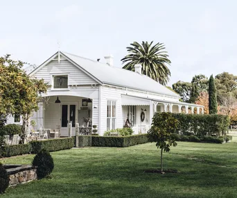 The façade of a white country style home with a verandah