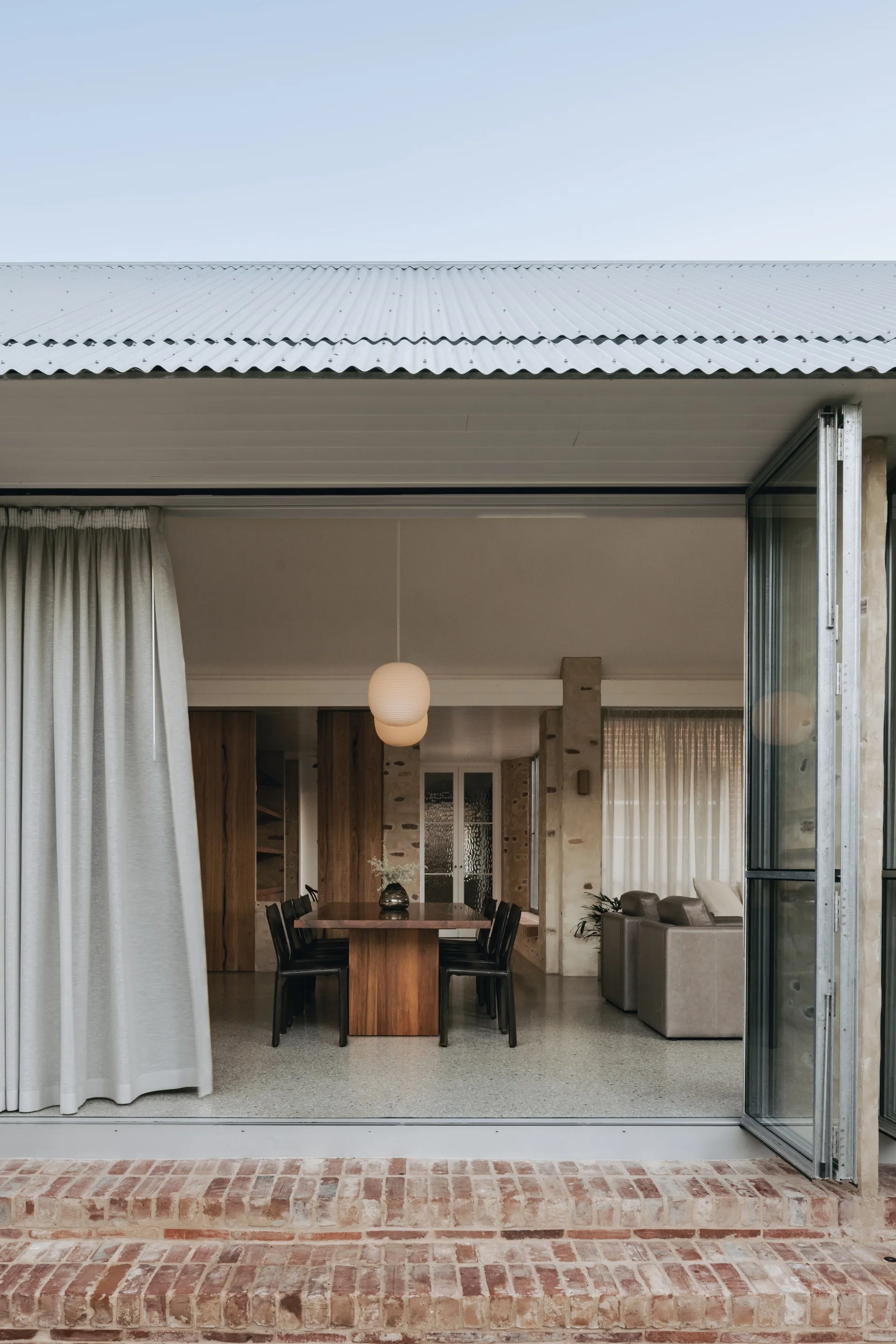 A dining space opening seamlessly out onto a garden through bi-fold doors