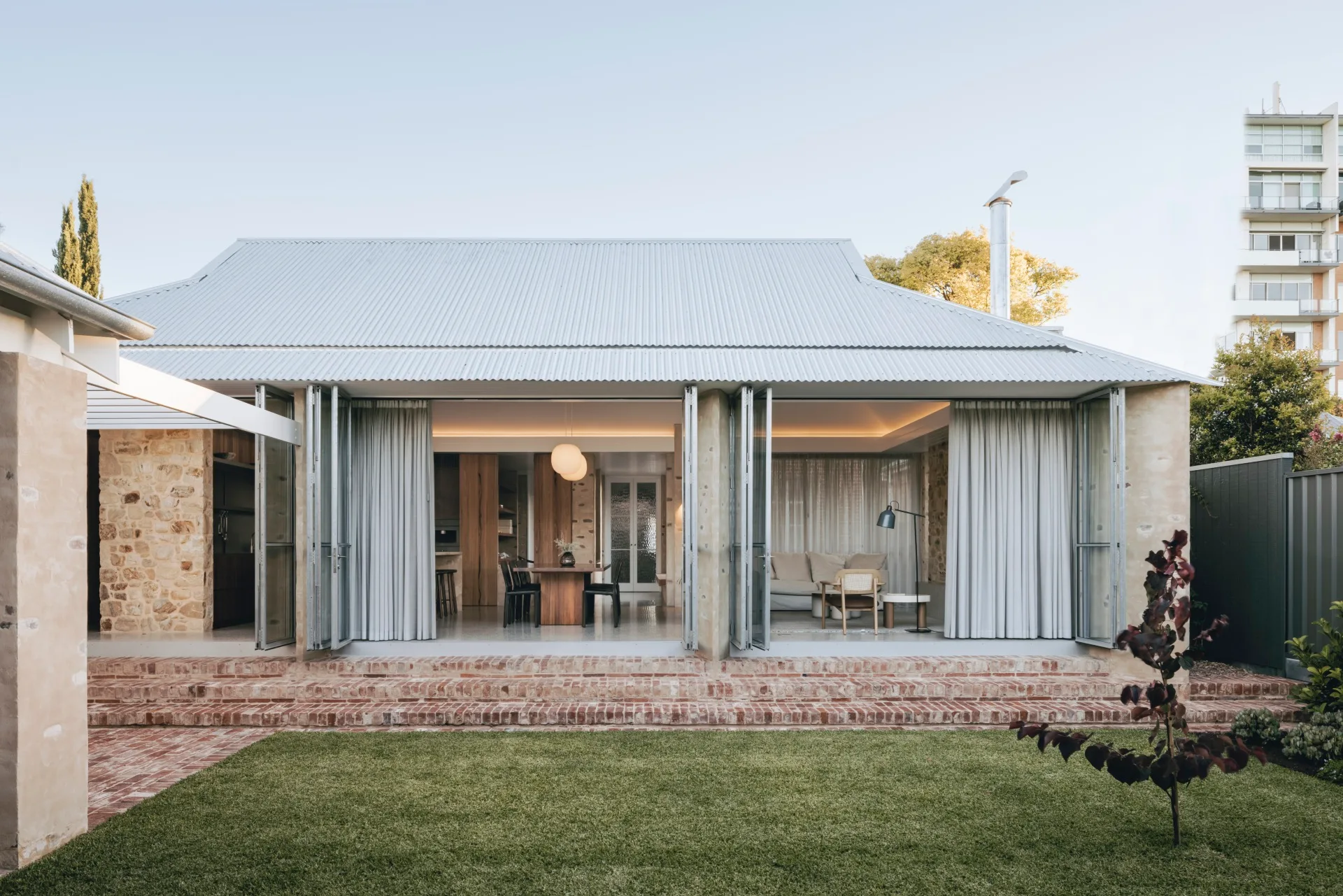 A renovated home in Rose Park sprawls out onto its lawn area through floor-to-ceiling bi-fold doors