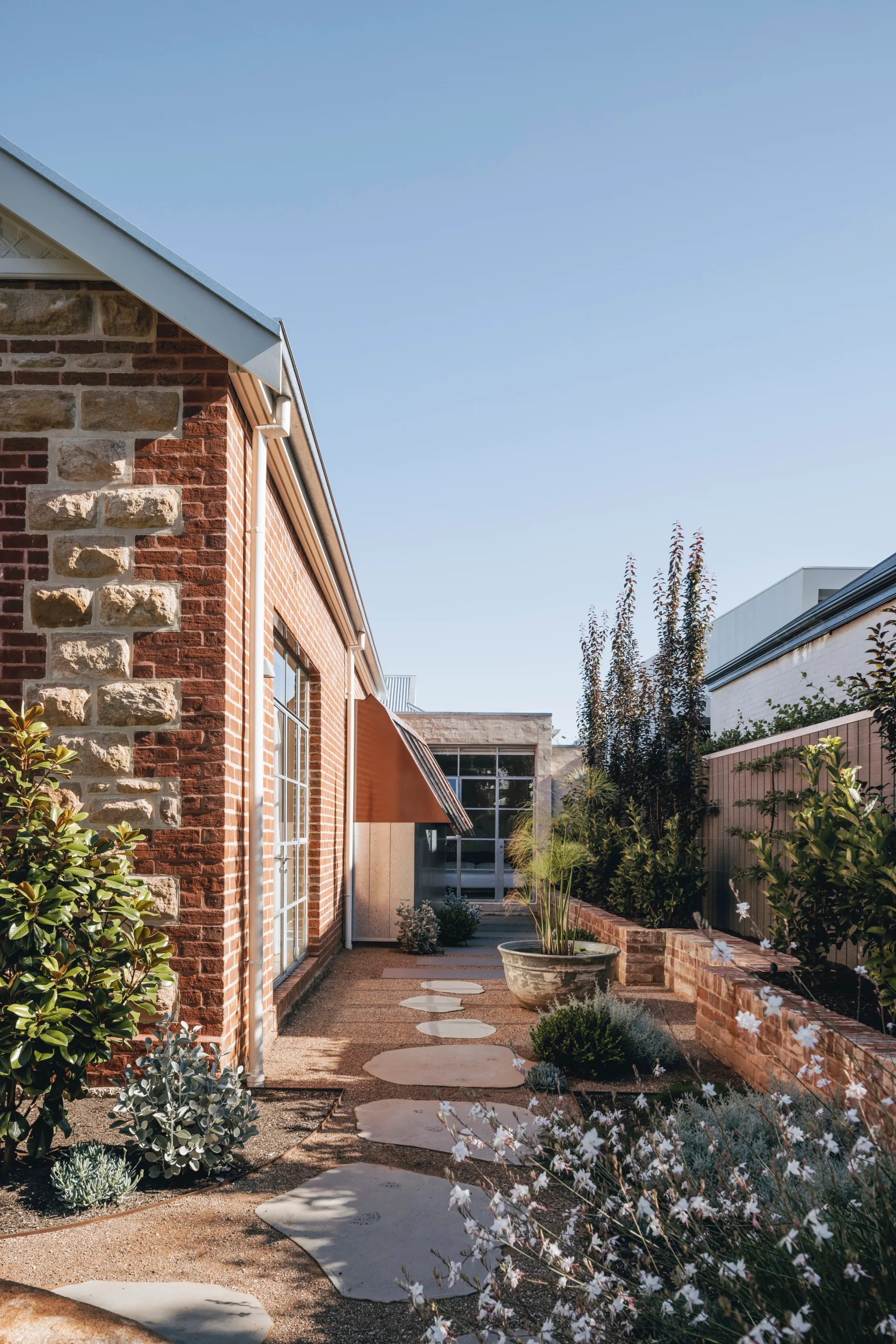A garden with stepping stones outside a heritage home in Rose Park
