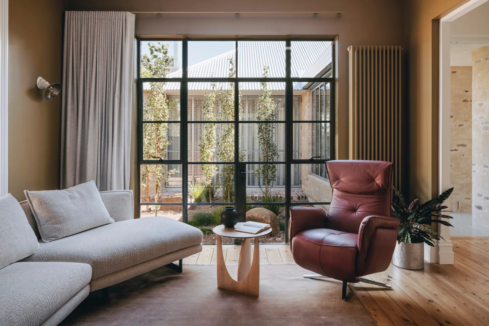 A contemporary lounge space with steel-frame windows