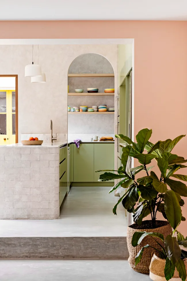 A contemporary kitchen with green cabinets