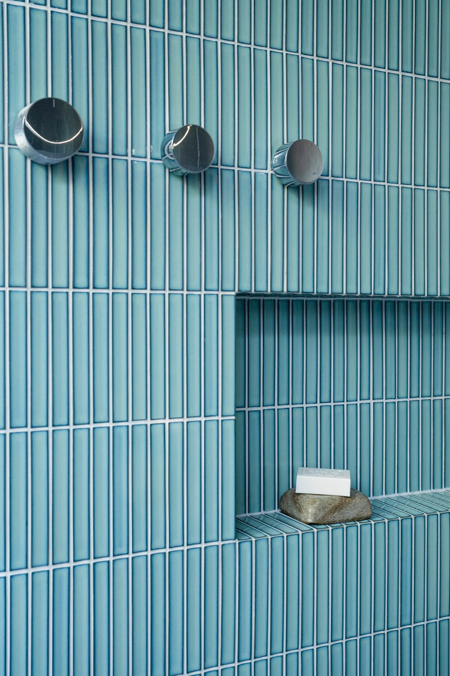 Close-up of a blue-tiled shower