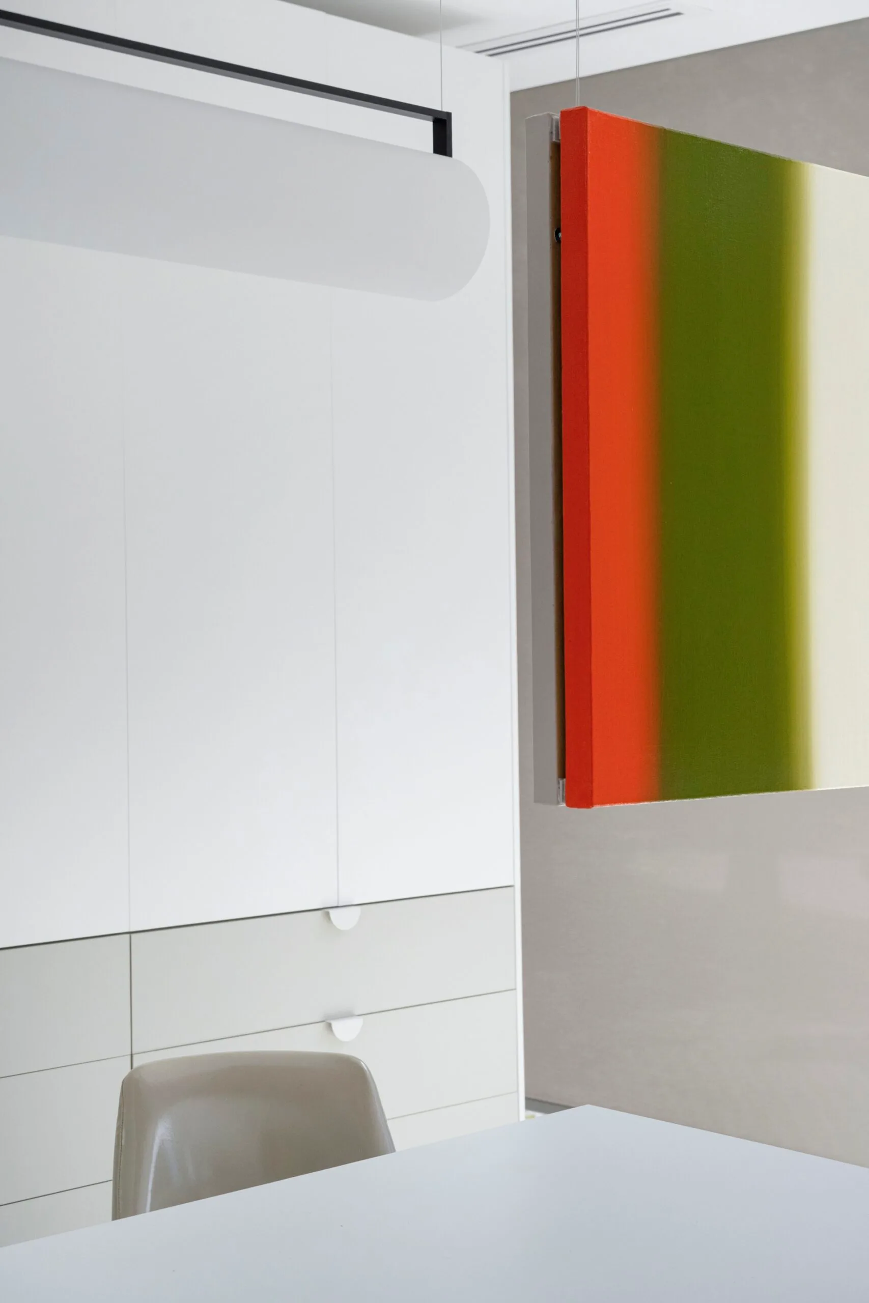 A hanging artwork above a desk