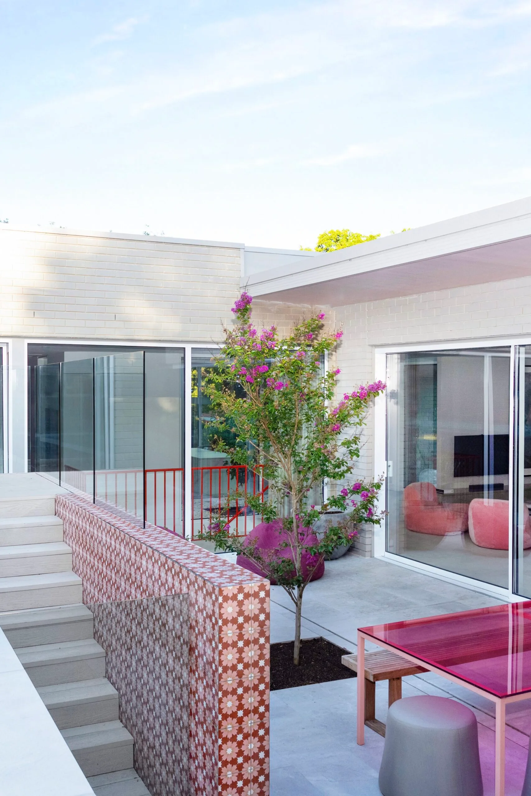 The modern exterior of a Canberra home where pink accents feature throughout