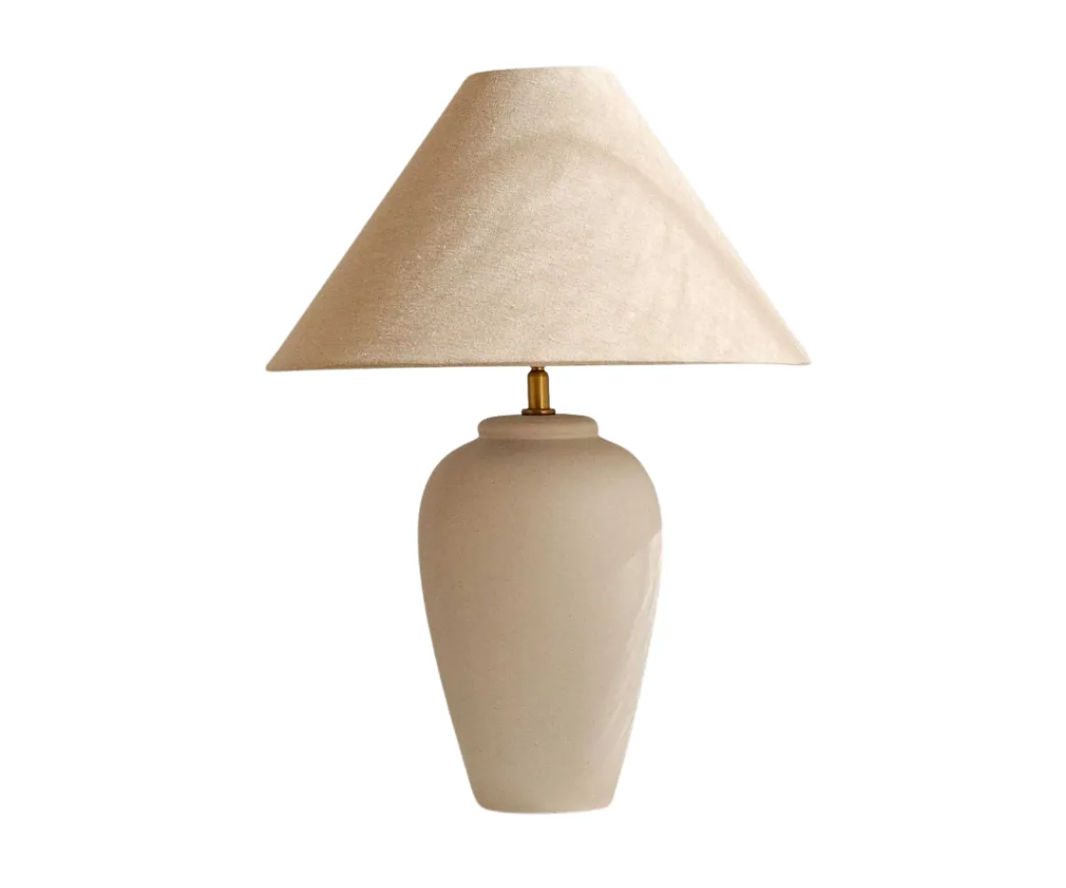 A white linen lamp with a  ceramic base